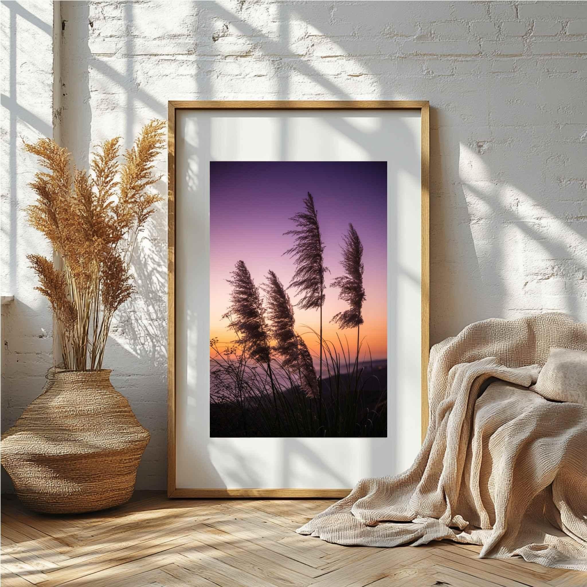 Coastal Pamper-Grass-Sunset by Abigail Diane Photography framed artwork of a sunset over tall pampas grasses in a room with a vase and blanket. Offered in Premium Fine Art Paper, Wrapped Canvas and Metal prints.