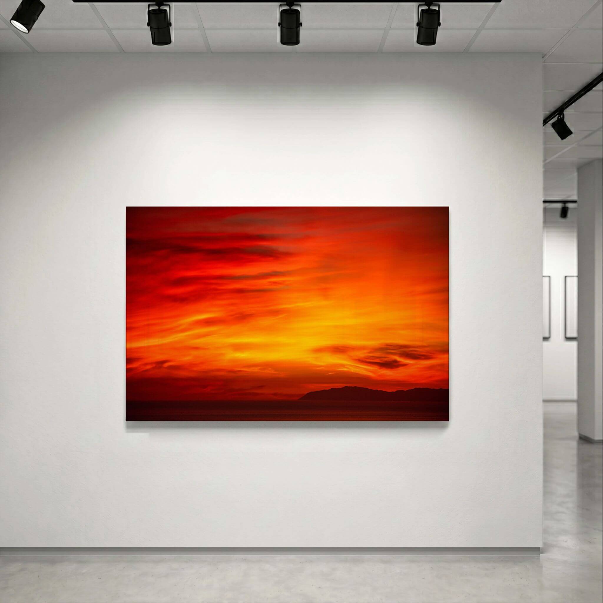 Inferno Sunset Catalina Island metal print displayed under gallery lighting, featuring dramatic crimson, orange and golden sunset skies over Catalina Island in the Pacific Ocean.