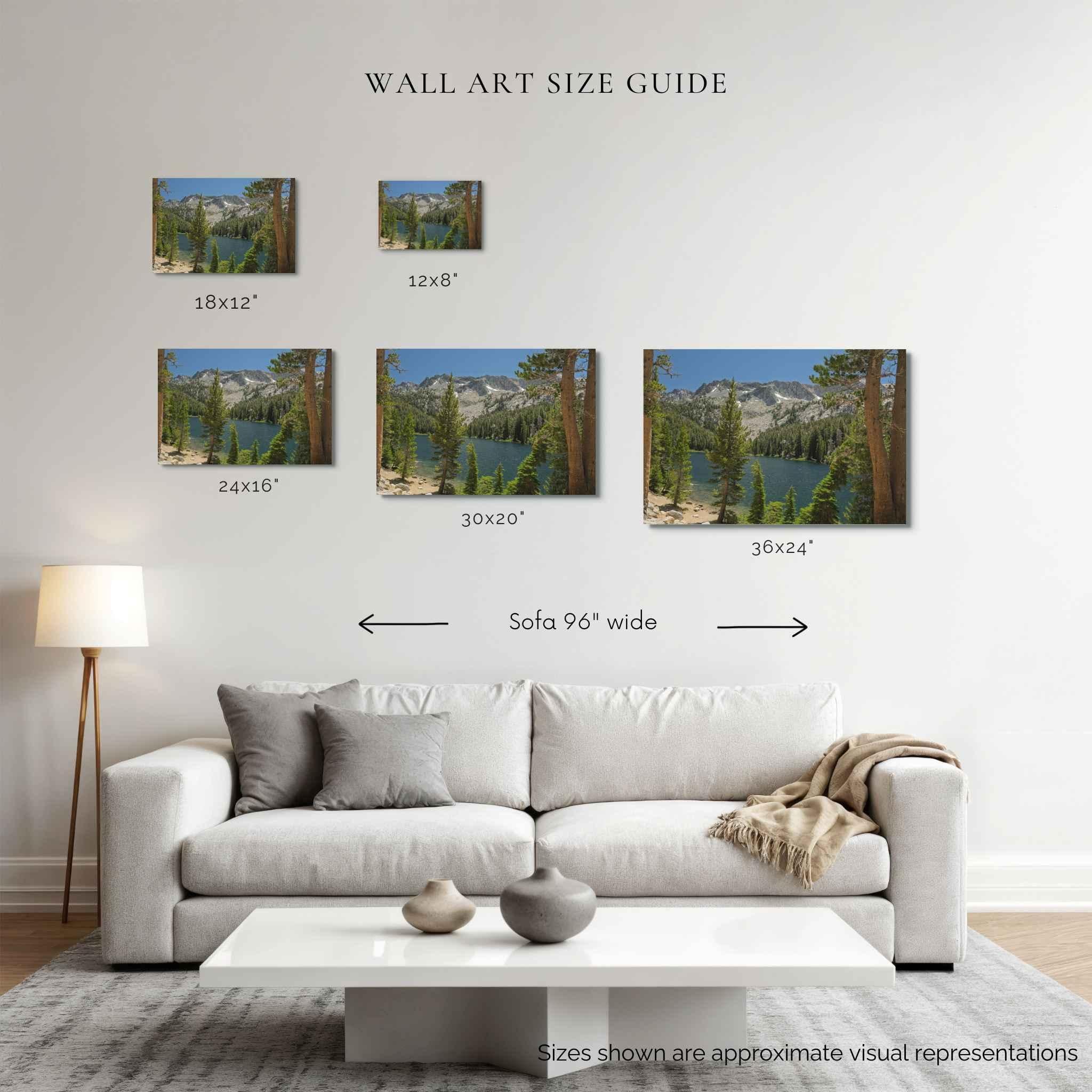 A wall art size guide displayed in a living room setting, showing five framed landscape prints above a white sofa with size labels for 10x12, 12x8, 24x10, 30x20, and 48x60 inch options. The prints depict mountain lakes with pine trees, in TJ Lake, California, and the image includes text noting the wall is 96 inches.