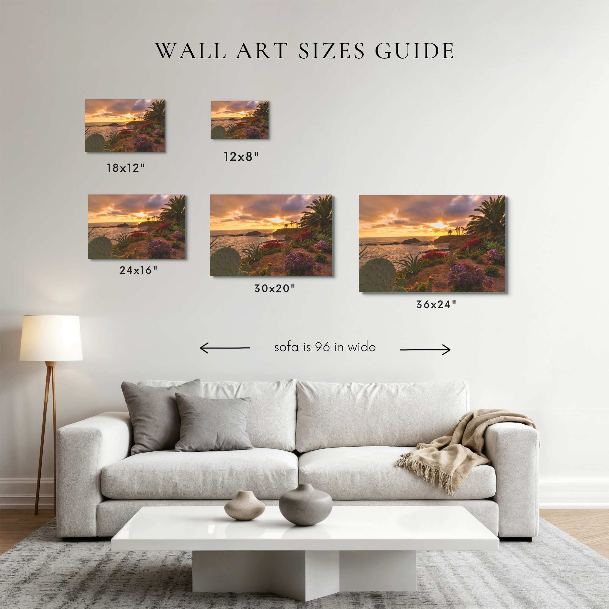 A wall art sizes guide displayed above a white sofa in a living room, showing six landscape canvas prints with dimensions labeled: 18x12", 12x8", 24x16", 30x20", 36x24", and a note that the sofa is 96 in wide.
