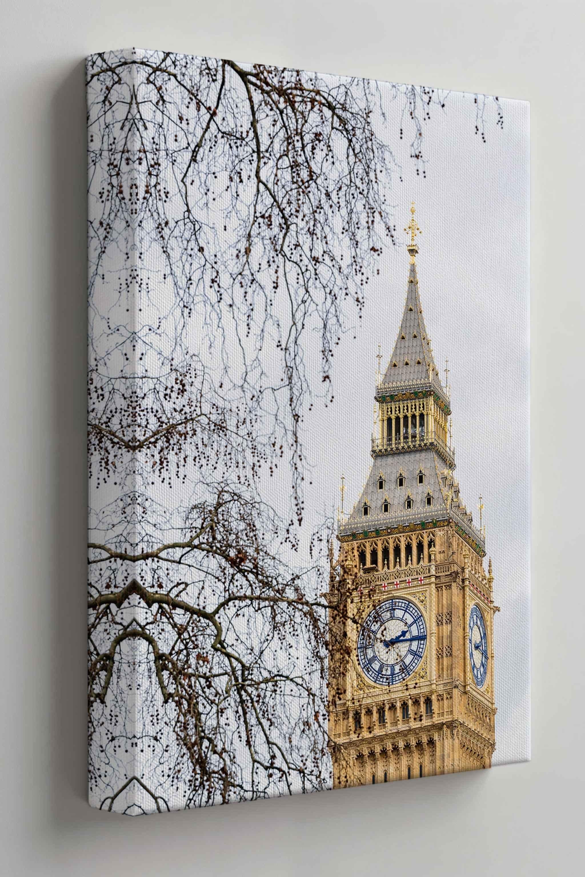 Gallery wrapped canvas print featuring the restored Big Ben clock tower in London, England, displayed on a soft warm neutral wall in a side-angle mockup highlighting the canvas depth and premium gallery wrap.