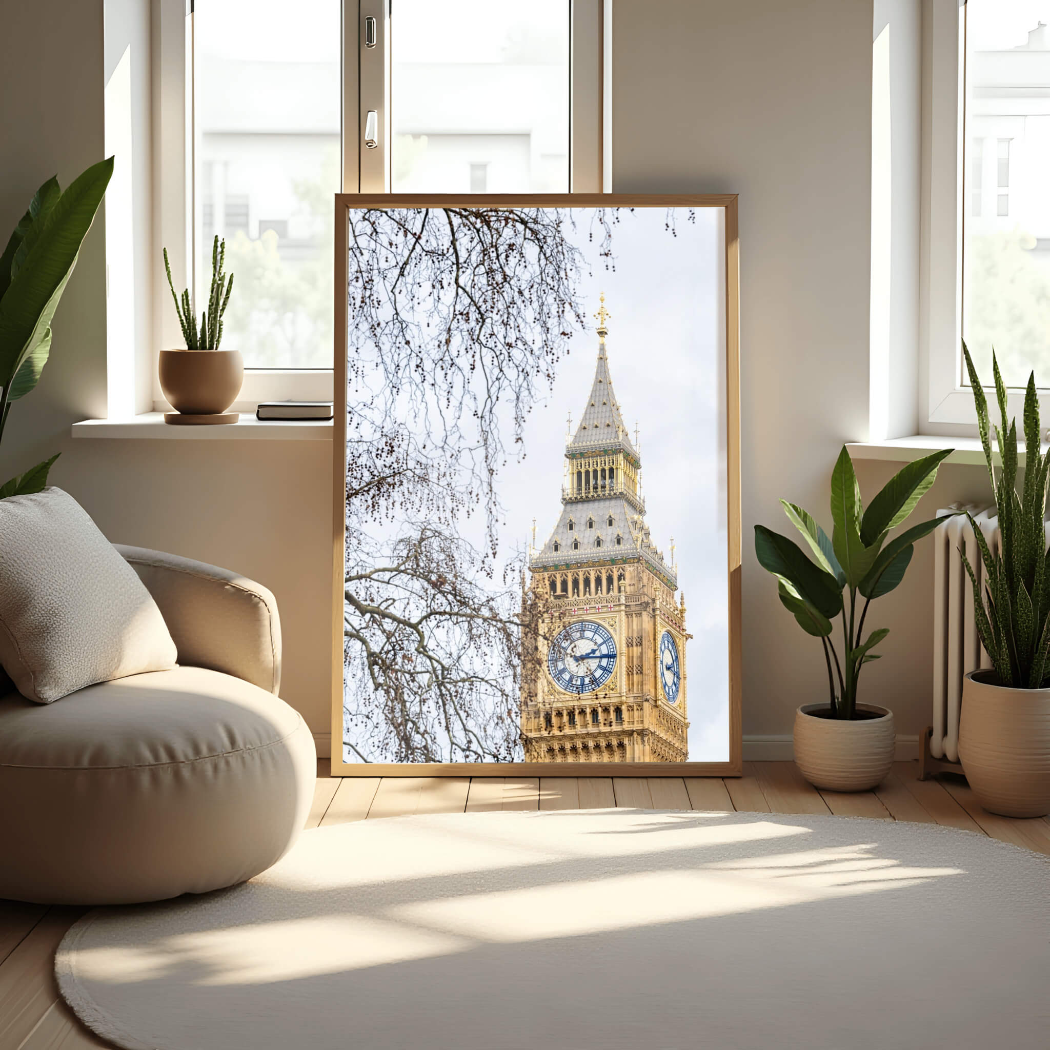 Large Big Ben London print by Abigail Diane Photography leaning against a wall in a sunlit neutral interior with soft furnishings and indoor plants, showcasing the iconic clock tower with natural light.