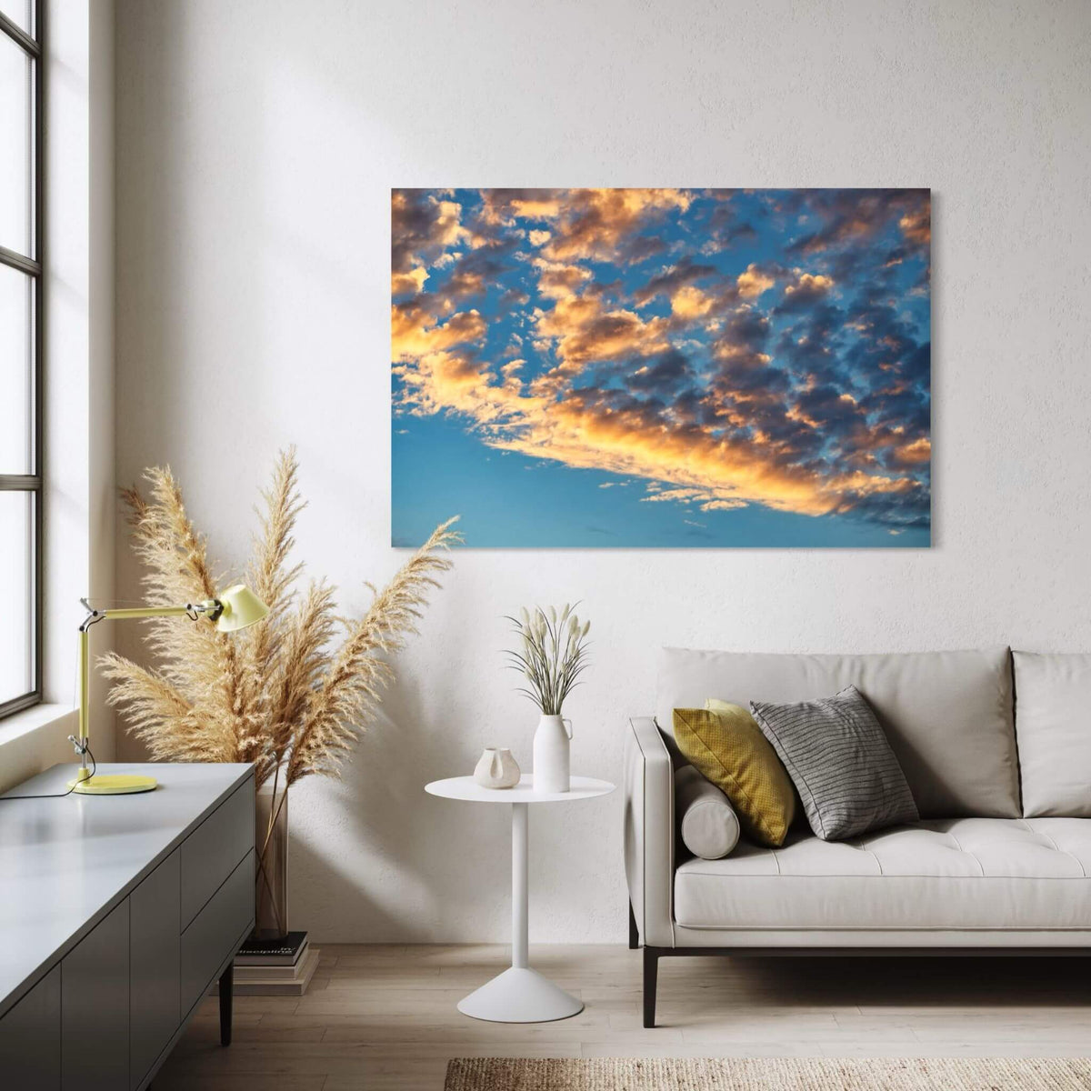 Blue and Gold Symphony canvas wall art featuring glowing golden clouds against a rich blue sky, displayed above a modern neutral chair in a contemporary interior.
This is a particularly strong mockup for the image, the restrained cream, natural wood and black accents make the blue and gold tones stand out beautifully.