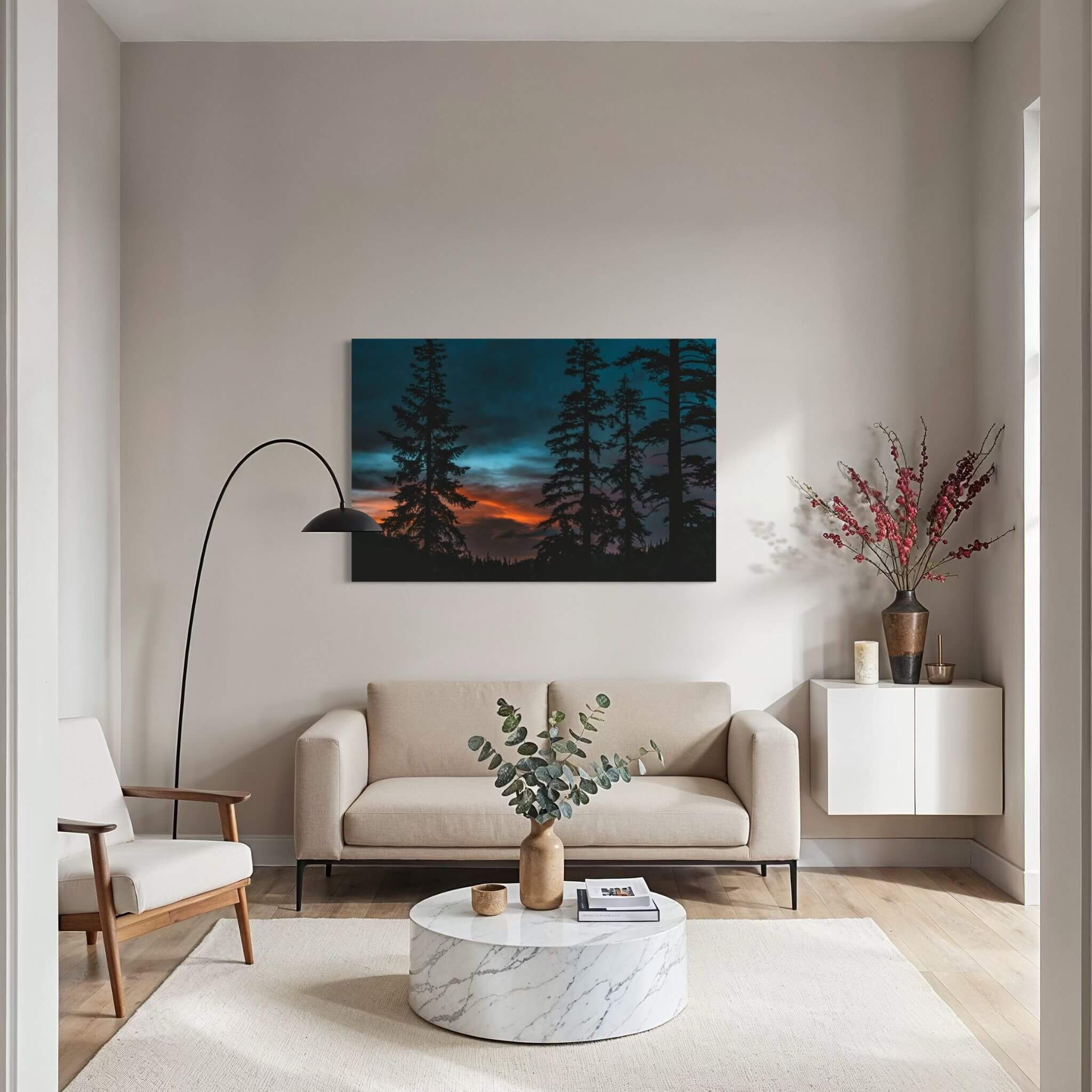 Blue Hour Among the Pines forest wall art displayed above a cream sofa in a contemporary living room with minimalist décor and soft neutral tones.