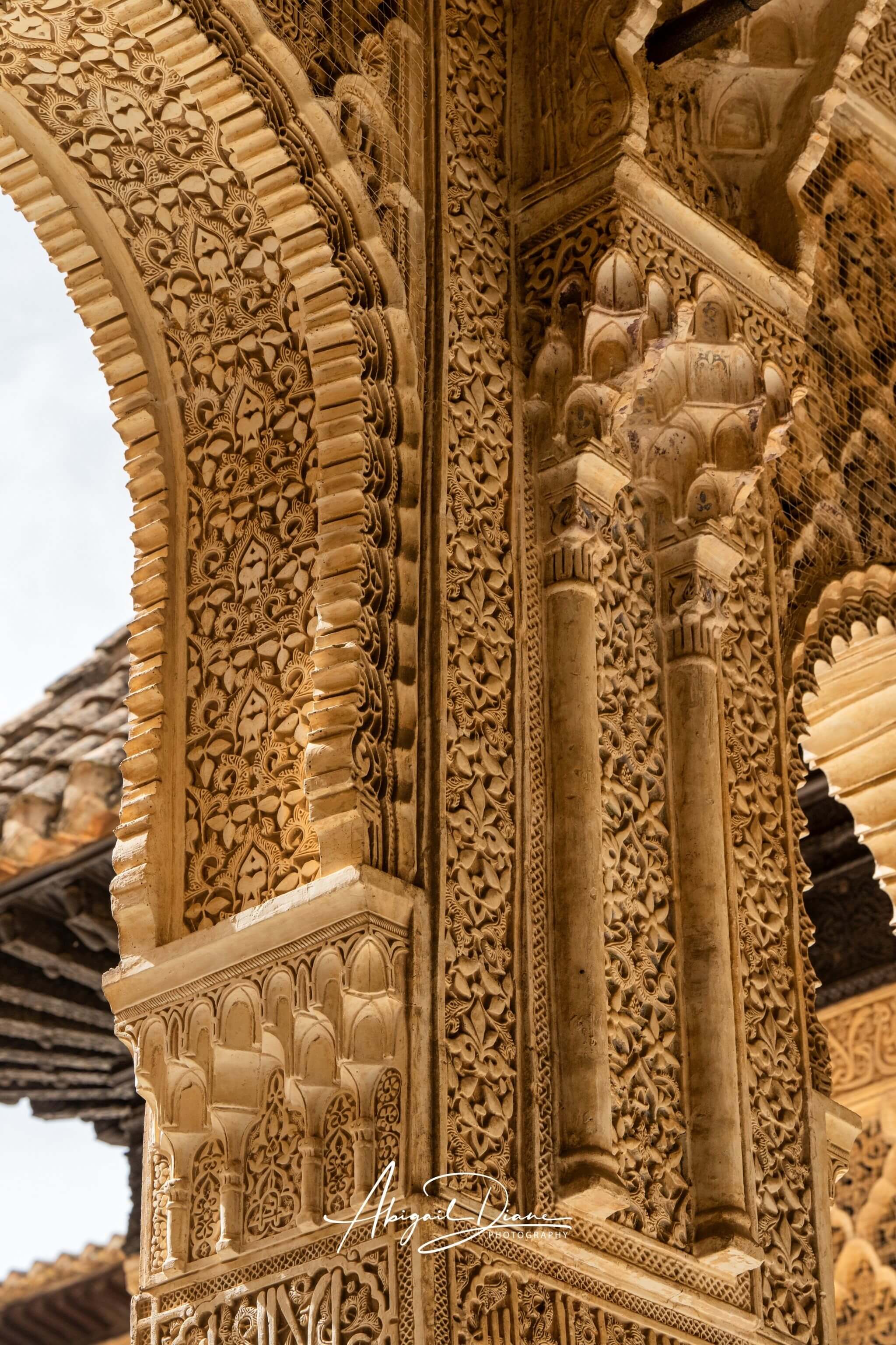 Carved Arches of the Alhambra featuring intricate Moorish architectural details in Granada, Spain by Abigail Diane Photography.
