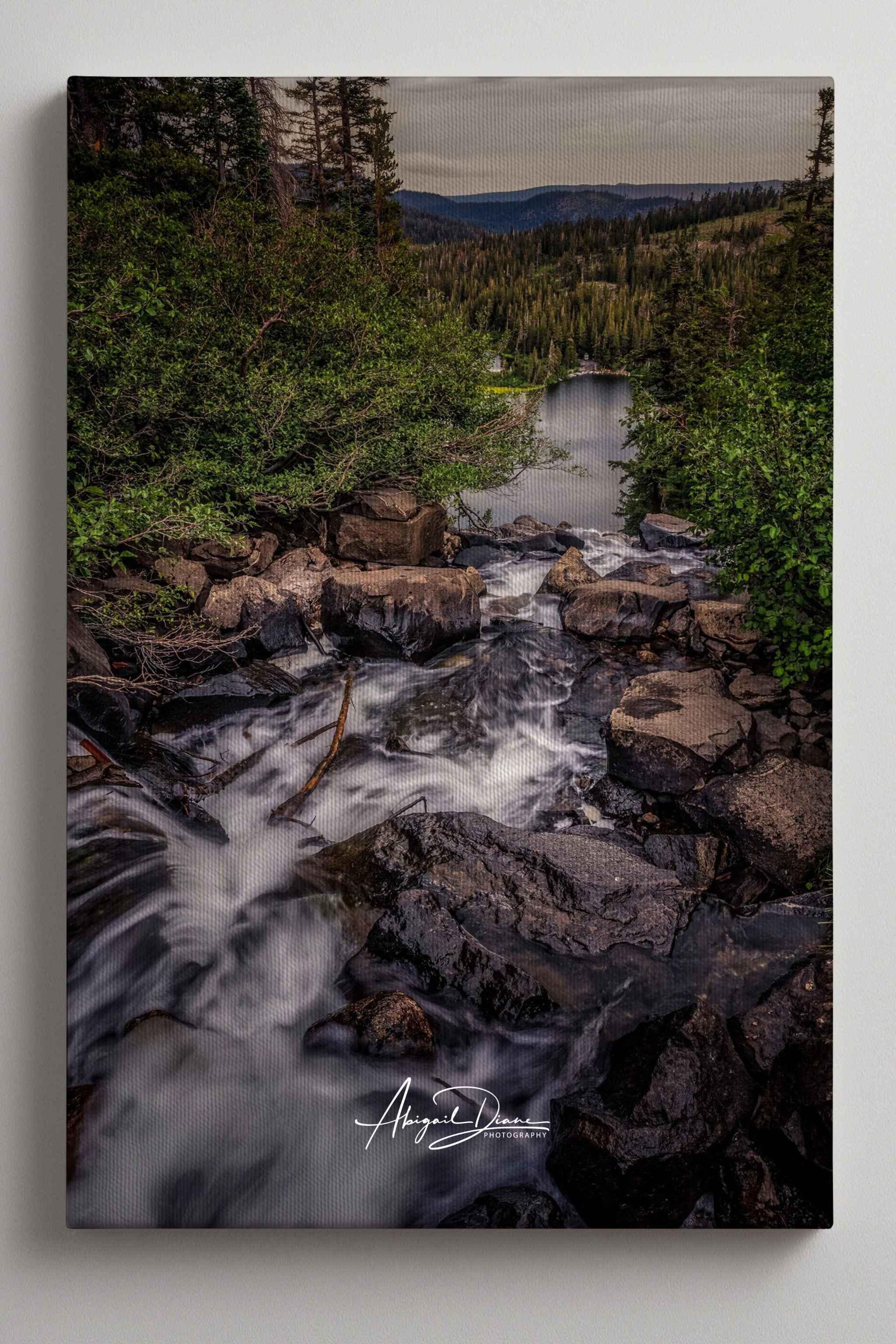 Cascading into Stillness giclée gallery-wrapped canvas featuring flowing mountain water, rugged rocks, and forested Twin Lakes in the Eastern Sierra, California.