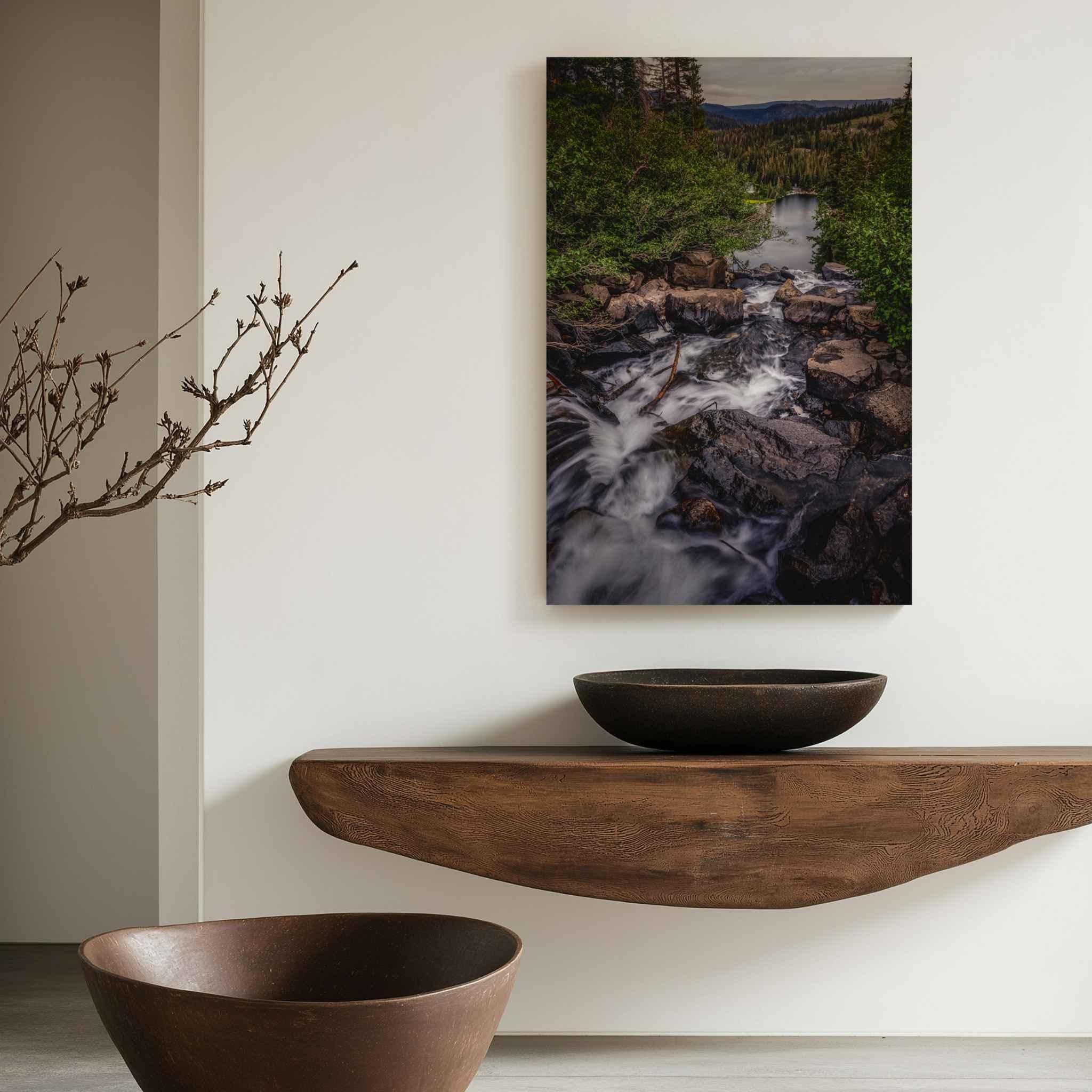 Mountain stream and waterfall metal print displayed in a minimalist interior, featuring flowing water, pine forest and mountain scenery in California’s Eastern Sierras.