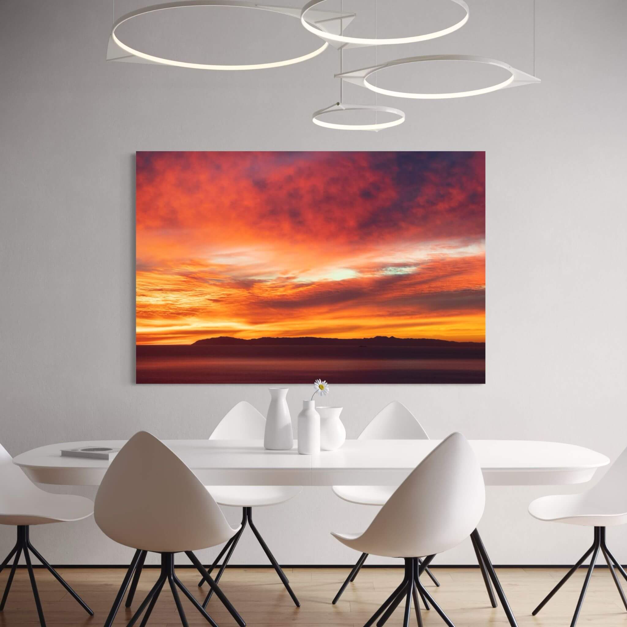 Catalina Beneath Crimson Skies metal print displayed in a contemporary dining room, featuring a dramatic crimson and golden California sunset. Photography by Abigail Diane Photography.