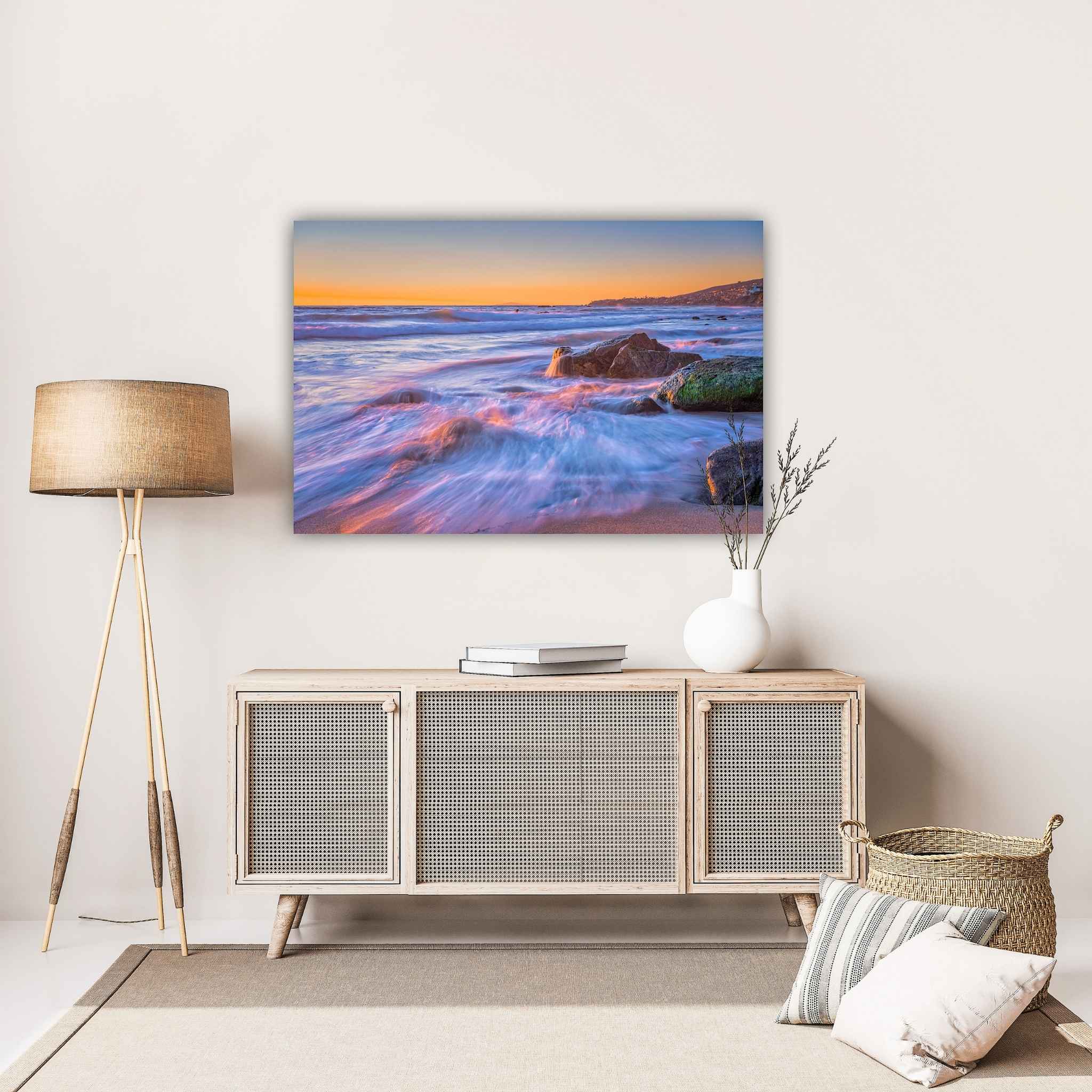 Cotton Candy Waves dye-sublimation metal print by Abigail Diane Photography displayed above a light wood console, showcasing pastel ocean waves at sunset in Laguna Beach, California.