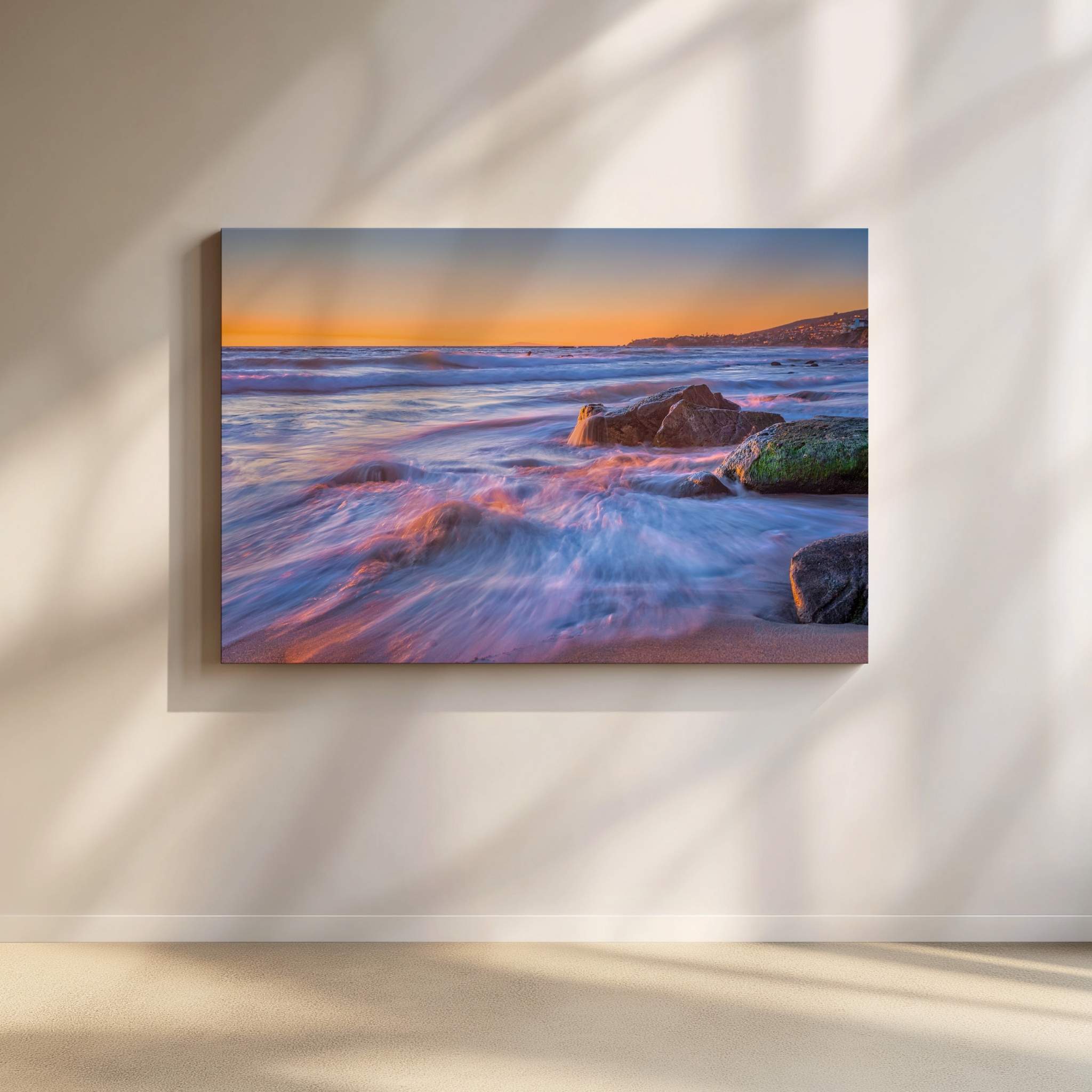 Cotton Candy Waves seascape wall art featuring silky pastel waves flowing around coastal rocks at sunset in Laguna Beach, California. Soft pink, lavender, and blue tones reflect across the Pacific Ocean beneath a glowing golden horizon, captured in a fine art photograph by Abigail Diane Photography.
