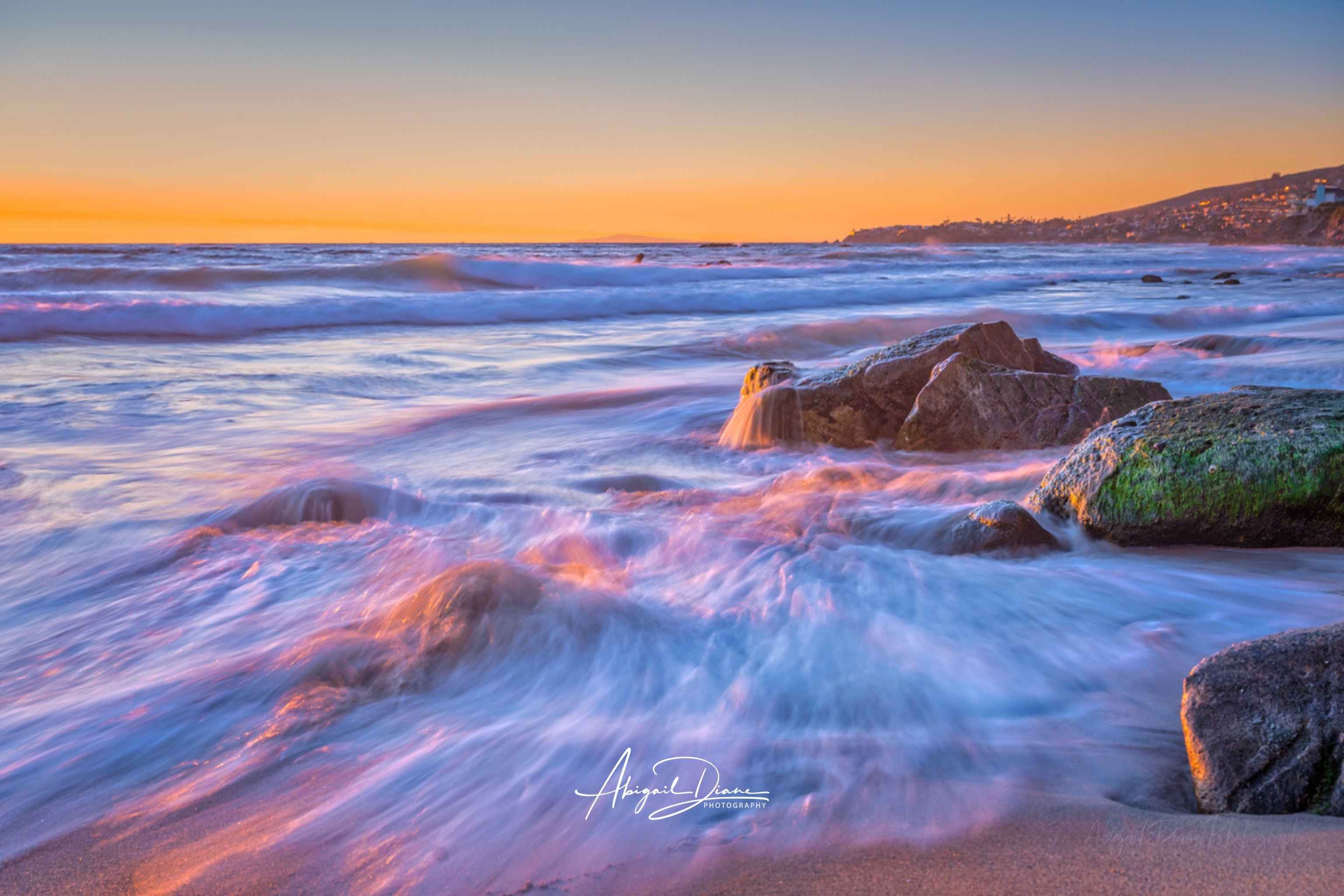 Cotton Candy Waves seascape metal wall art by Abigail Diane Photography. capturing flowing pastel waves and warm sunset light along the shoreline in Laguna Beach, California.
