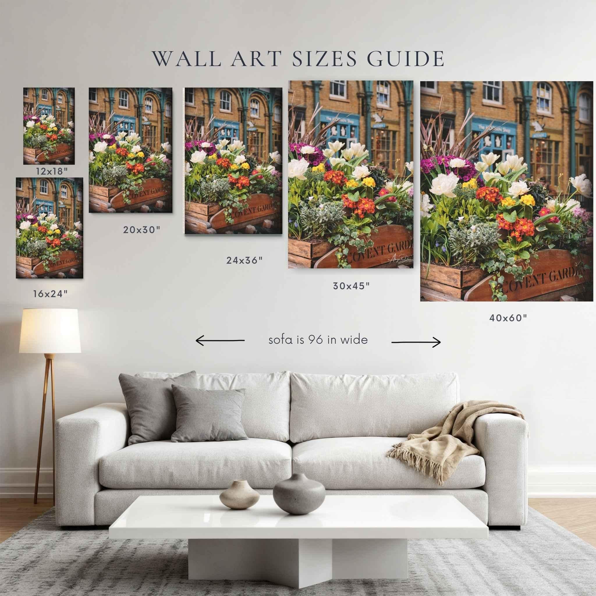 Wall art size guide by Abigail Diane Photography showing "Covent Garden in Bloom" canvas print in 12x18, 16x24, 20x30, 24x36, 30x45, and 40x60 inch sizes above a 96-inch sofa in a bright, modern living room.