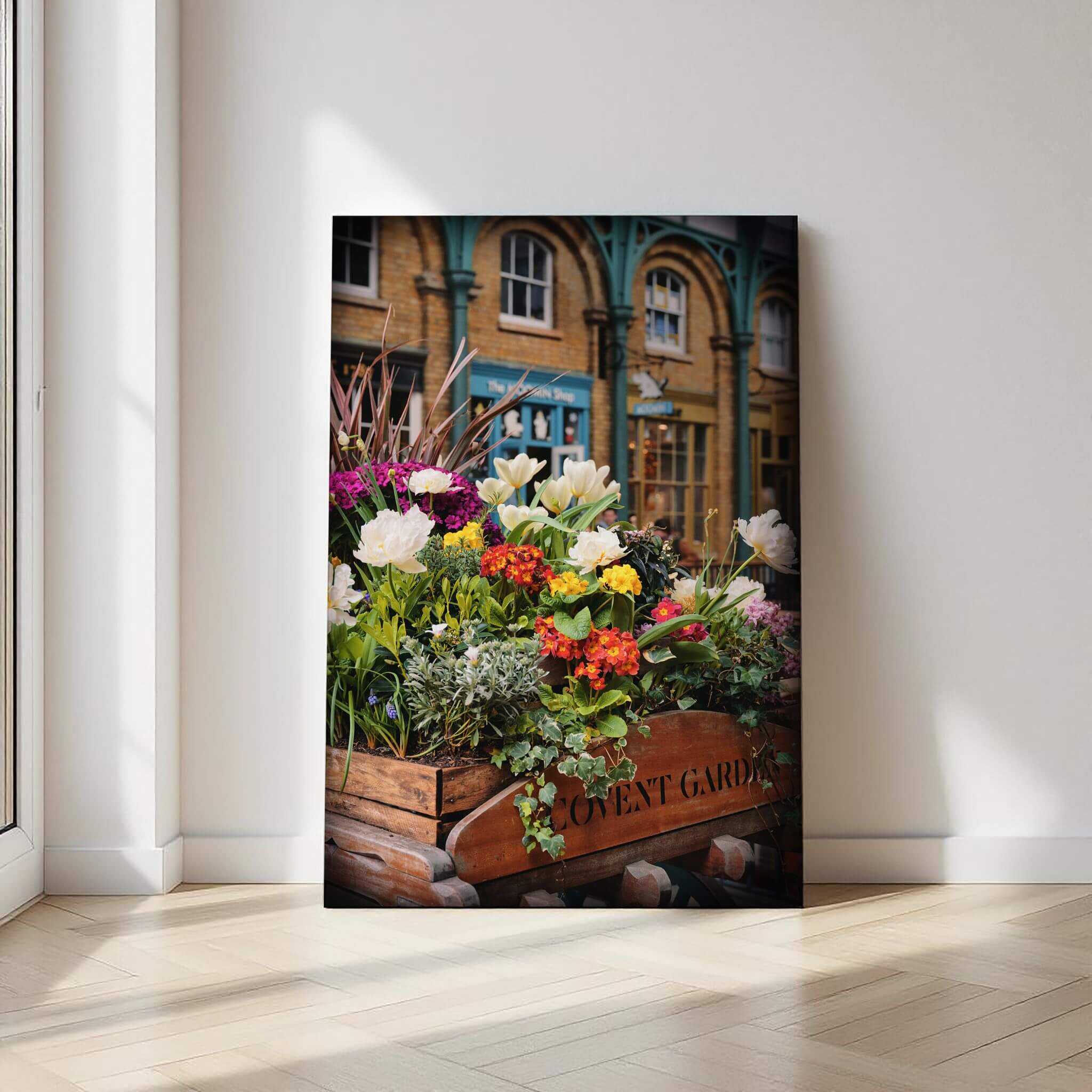 Covent Garden in Bloom fine art print displayed against a softly lit neutral wall, showcasing the colorful floral scene and London character.