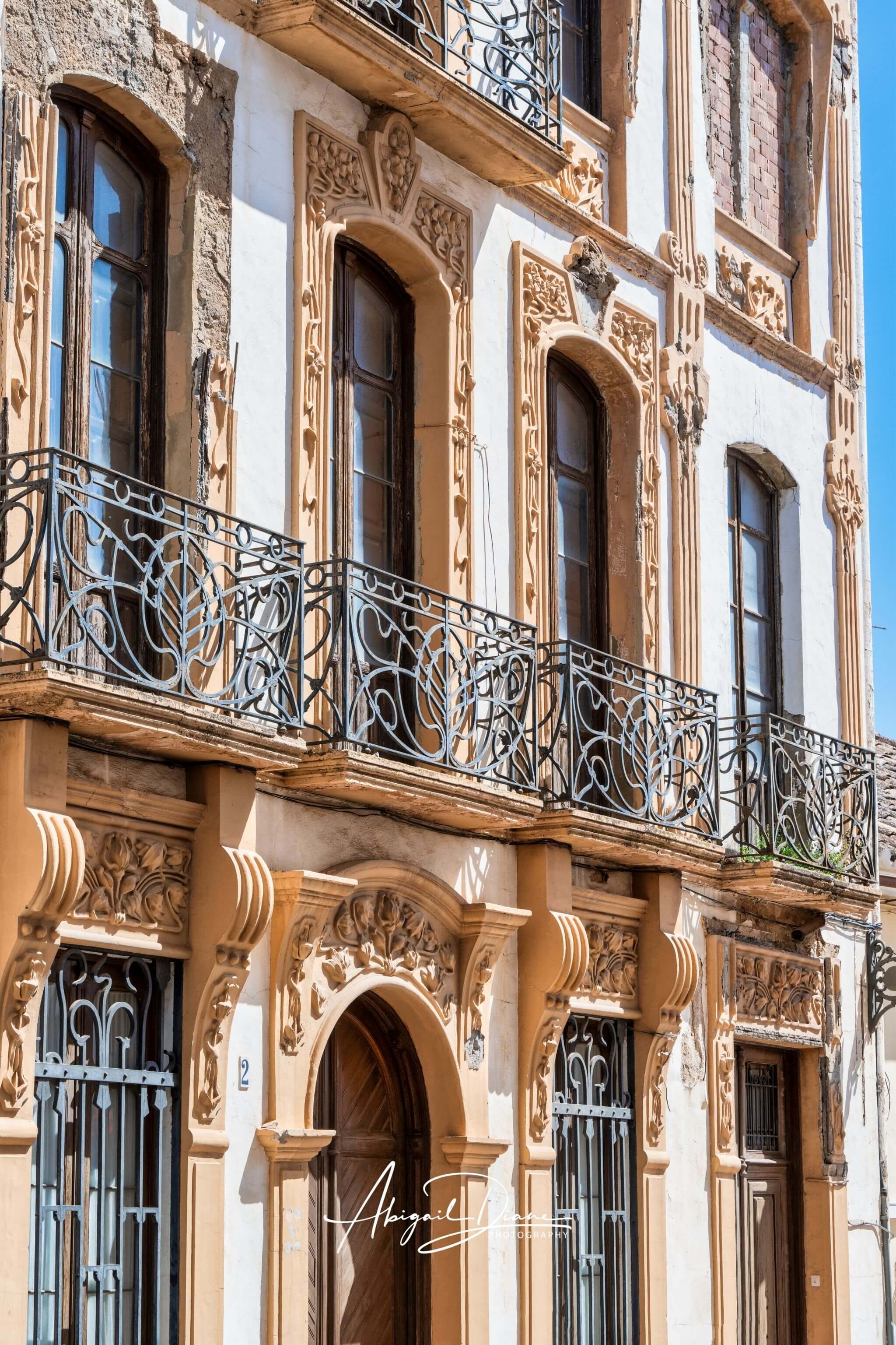Elegance of Ronda featuring ornate architectural details, traditional wrought-iron balconies and historic Andalusian architecture in Ronda, Spain . Photographed by Abigail Diane Photography.