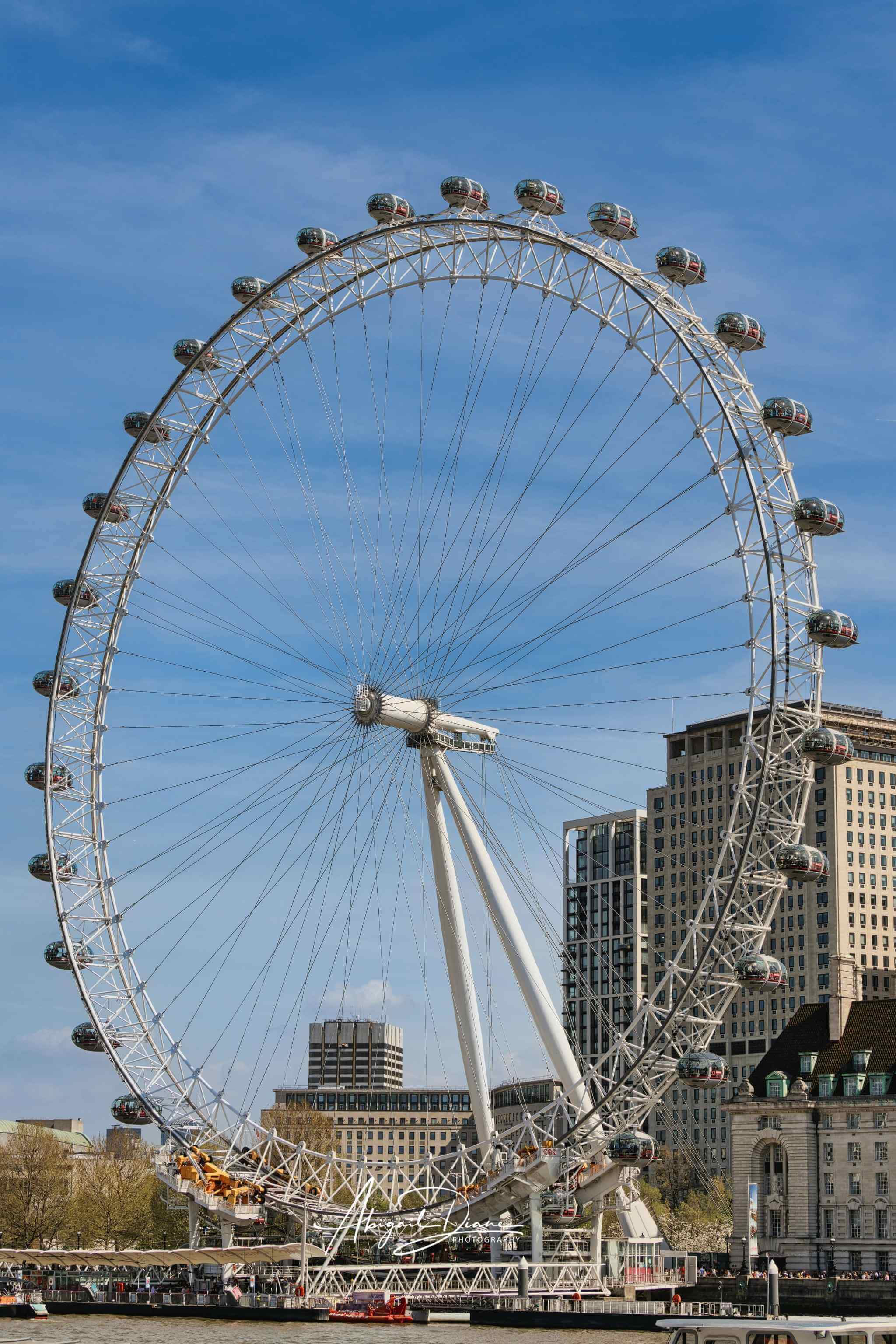 Eye Above London photograph featuring the London Eye against a clear blue sky in Central London, England. Photographed by Abigail Diane Photography.