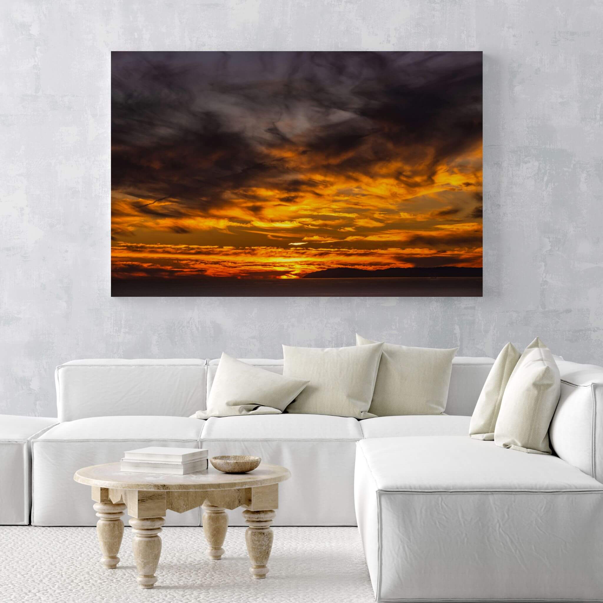 Golden Gleaming Sunset Laguna Beach sunset HD metal wall art displayed above a contemporary white sectional, bringing dramatic golden skies and coastal elegance into the space.