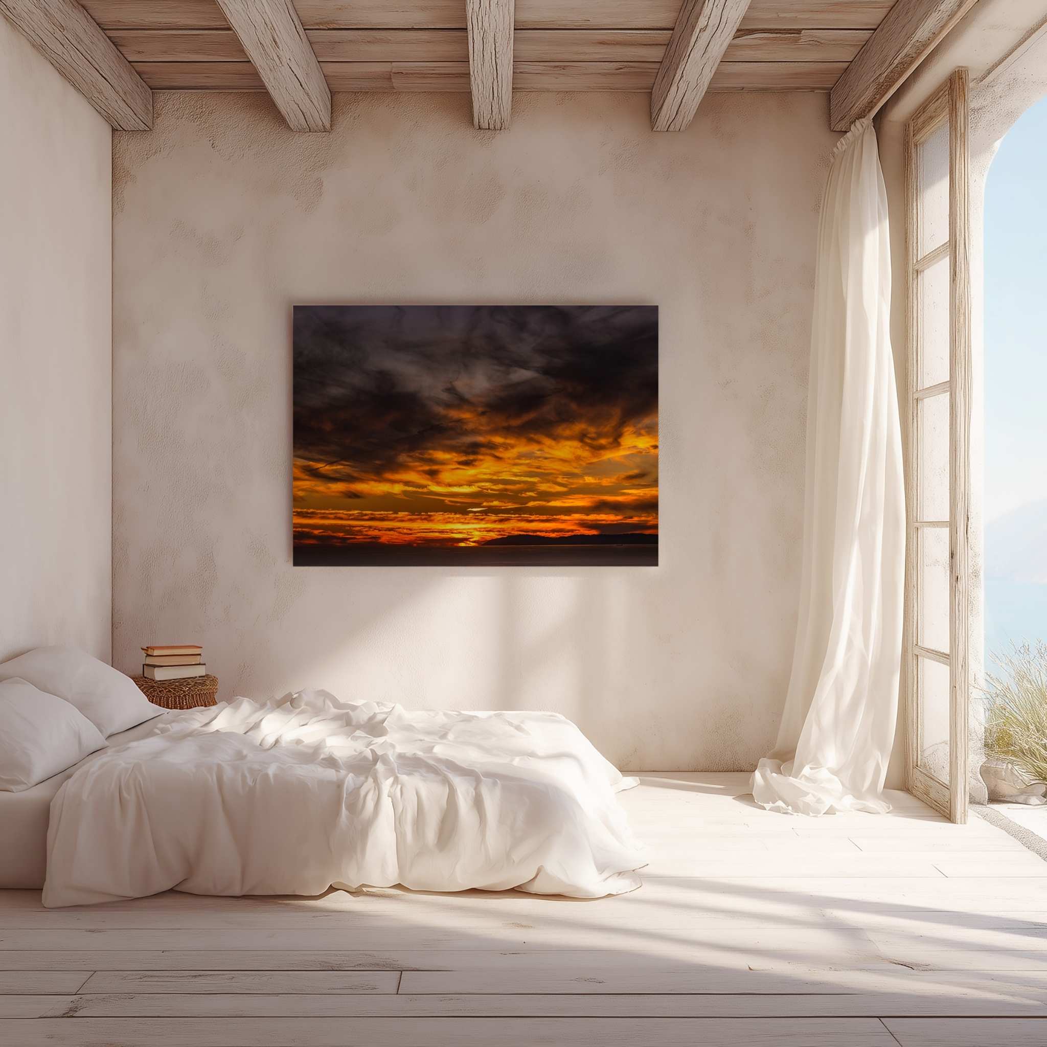 Gallery wrapped canvas featuring a dramatic golden sunset displayed above a bed in a bright Mediterranean-inspired bedroom with exposed wooden beams.