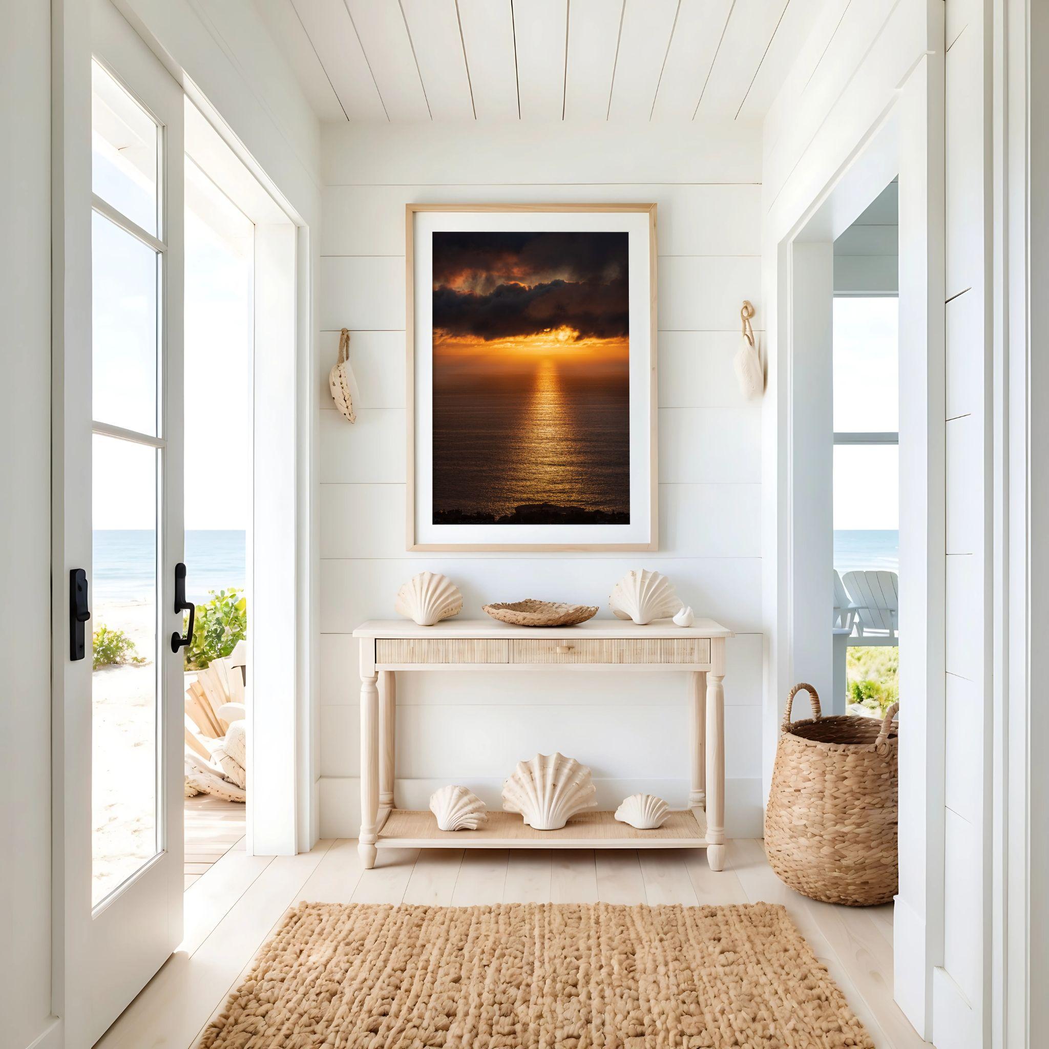 Golden Rays on the Mirrored Sea of the Pacific by Abigail Diane Photography displayed as a natural wood framed coastal sunset print in a bright beach house entryway with ocean-inspired décor.