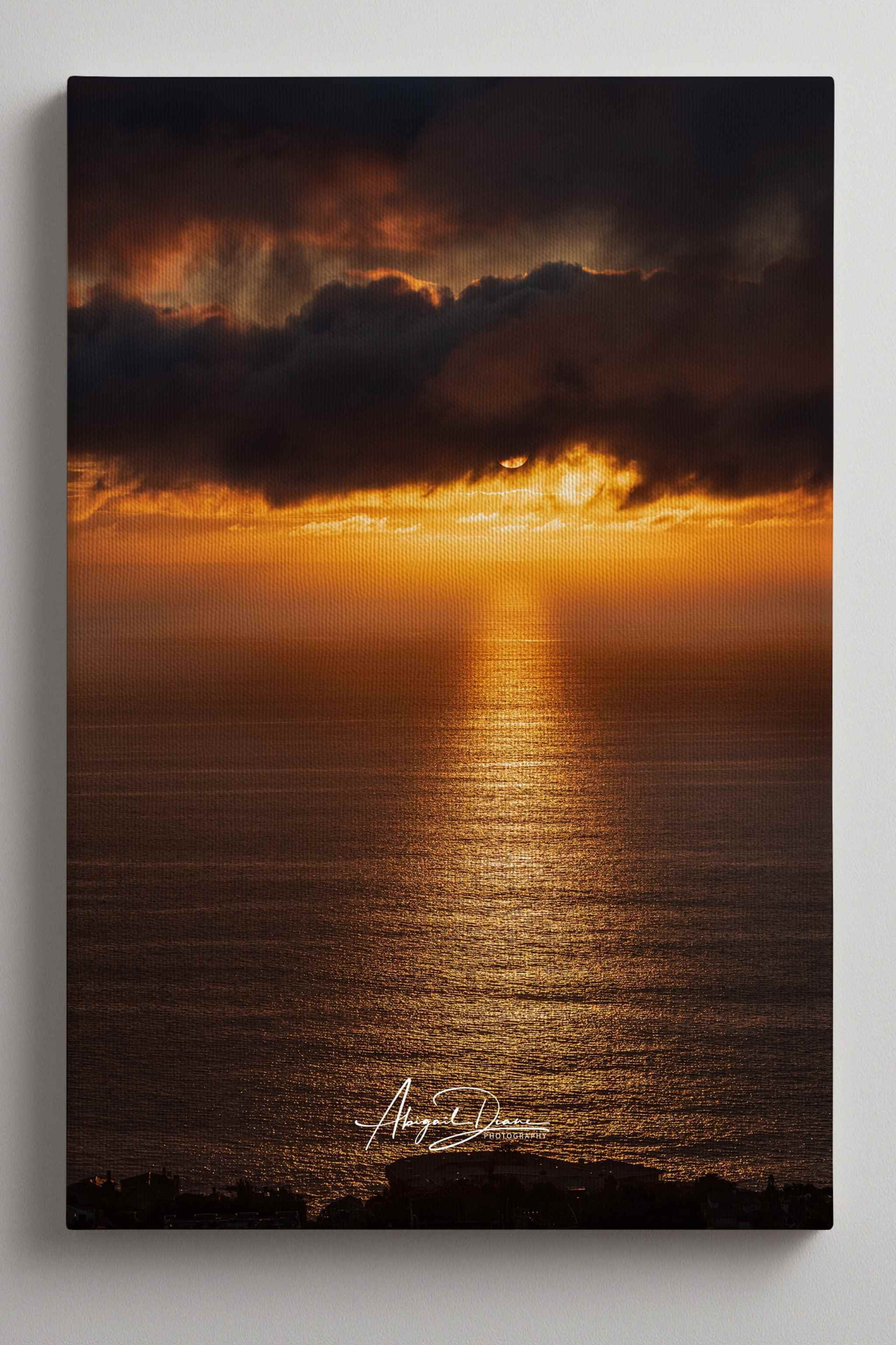 Close-up of Abigail Diane Photography's Laguna Beach Winter Sunset wrapped canvas print showcasing gallery-wrapped edges and premium canvas texture. This fine art coastal landscape captures dramatic winter storm clouds, glowing golden sunlight reflecting across the Pacific Ocean, and rich amber tones, highlighting the craftsmanship and depth of a museum-quality canvas ready to hang in modern, coastal, or contemporary interiors.