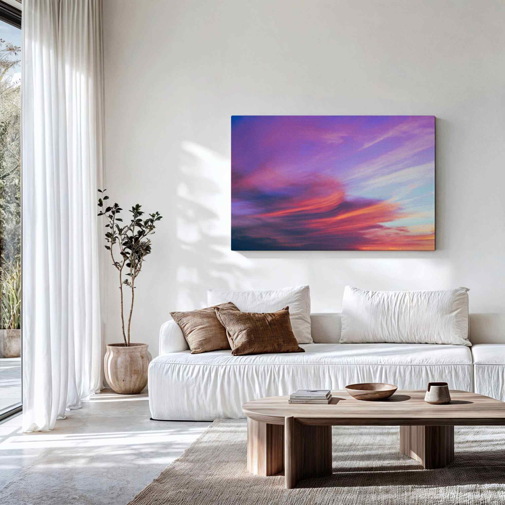 Gallery wrapped canvas of Lavender Dreams displayed above a modern white sofa, featuring a dreamy pastel cloudscape with lavender, pink, and blue skies. Fine art wall decor by Abigail Diane Photography.