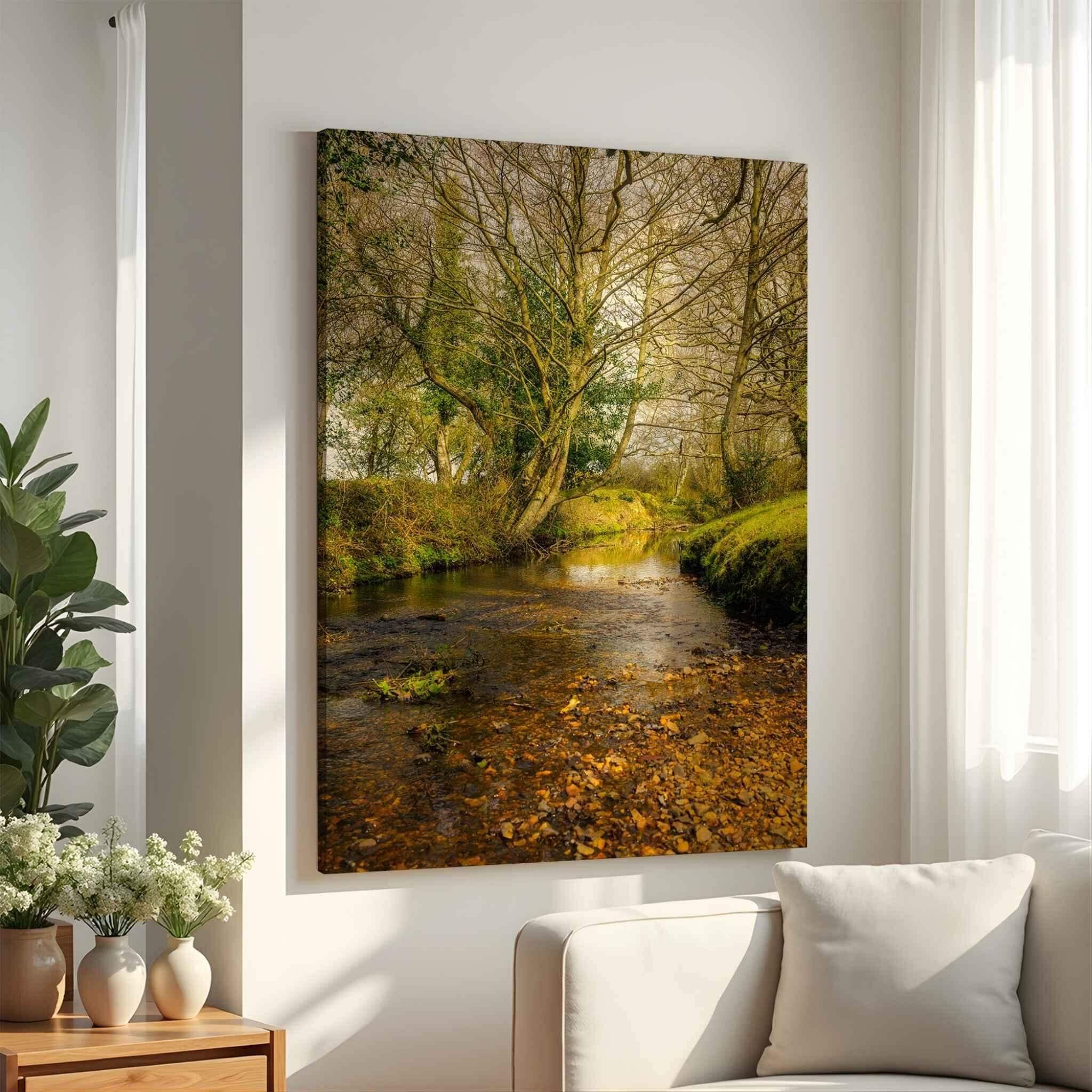 Large canvas print of Lazy Creek in the New Forest, UK by Abigail Diane Photography featuring a peaceful woodland stream in warm golden light displayed in a modern living room.