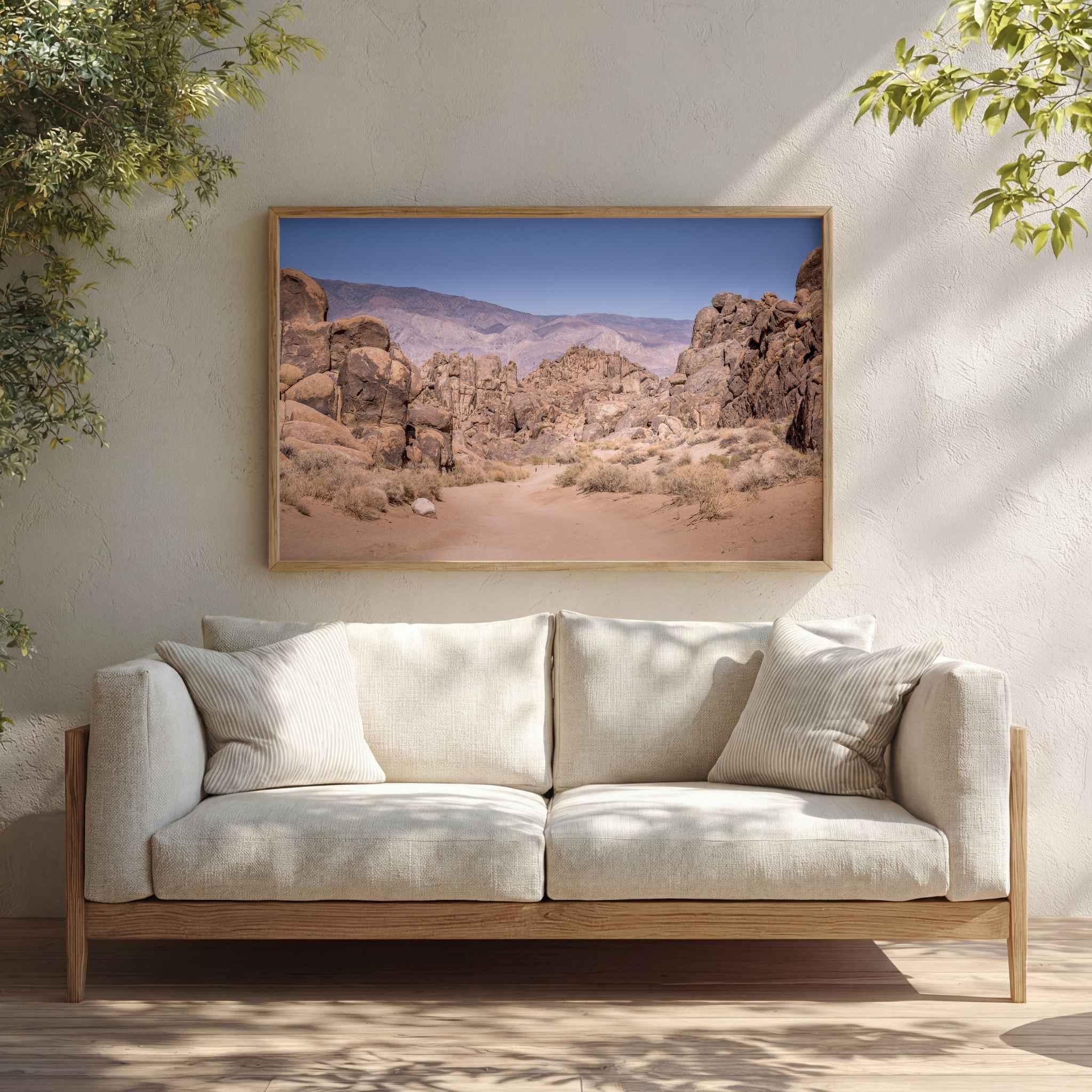 Sierra Desert Passage framed fine art print featuring California’s Eastern Sierra desert landscape displayed above a cream sofa in a warm natural living room.