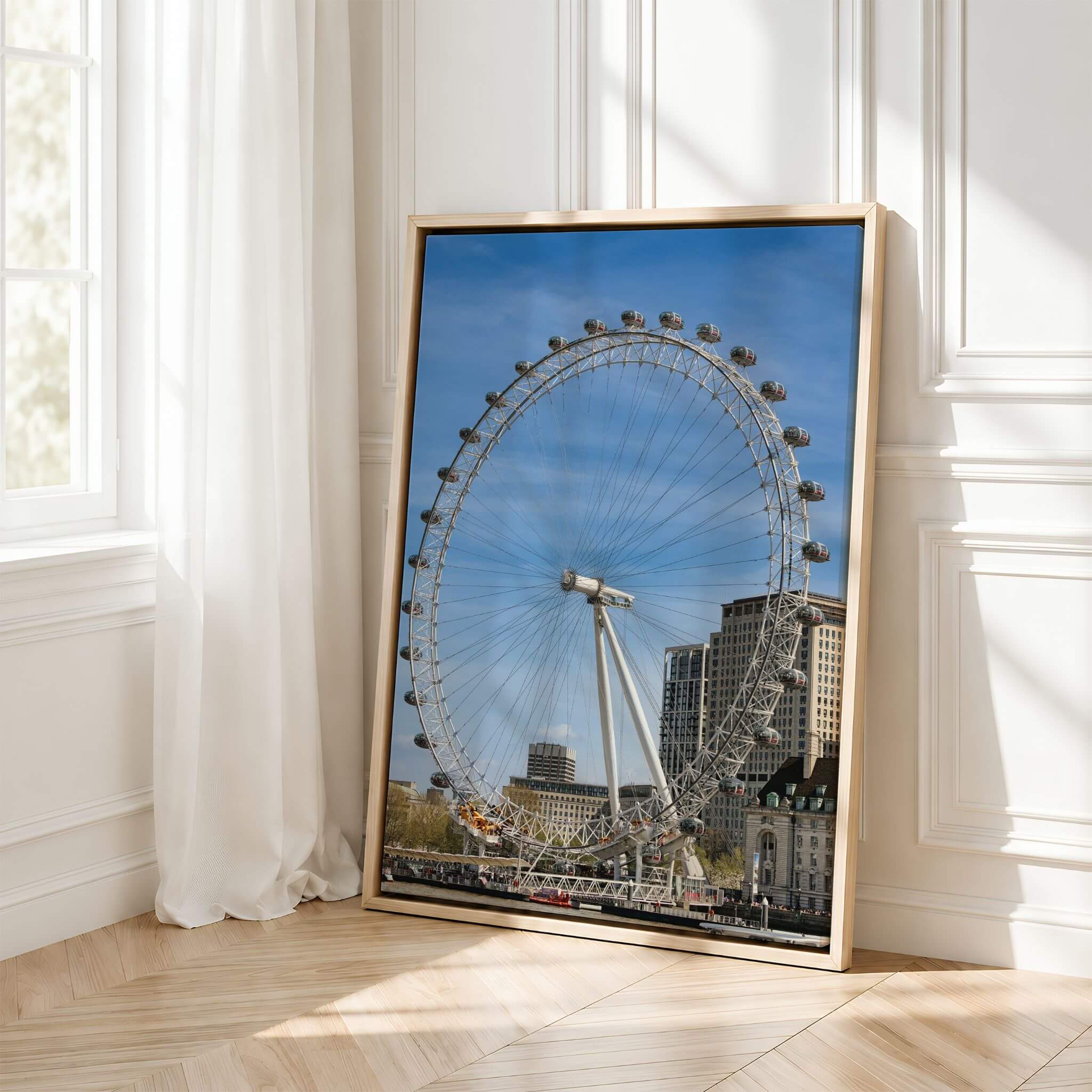 Large London Eye fine art print displayed in a natural wood frame in a bright elegant interior with soft natural light.