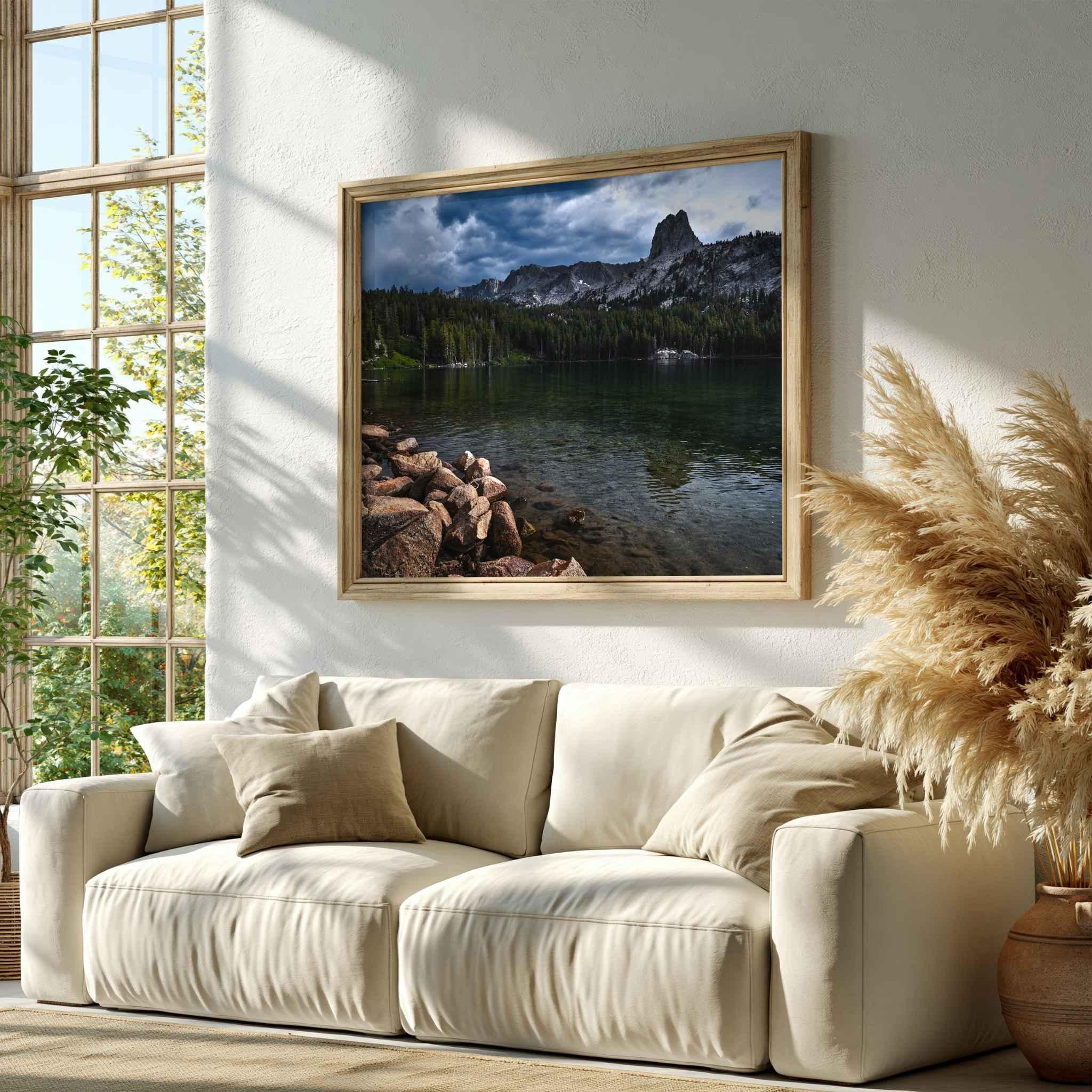 Framed Reflections on Lake Mary landscape photography displayed above a neutral sofa in a warm natural living room with pampas grass.