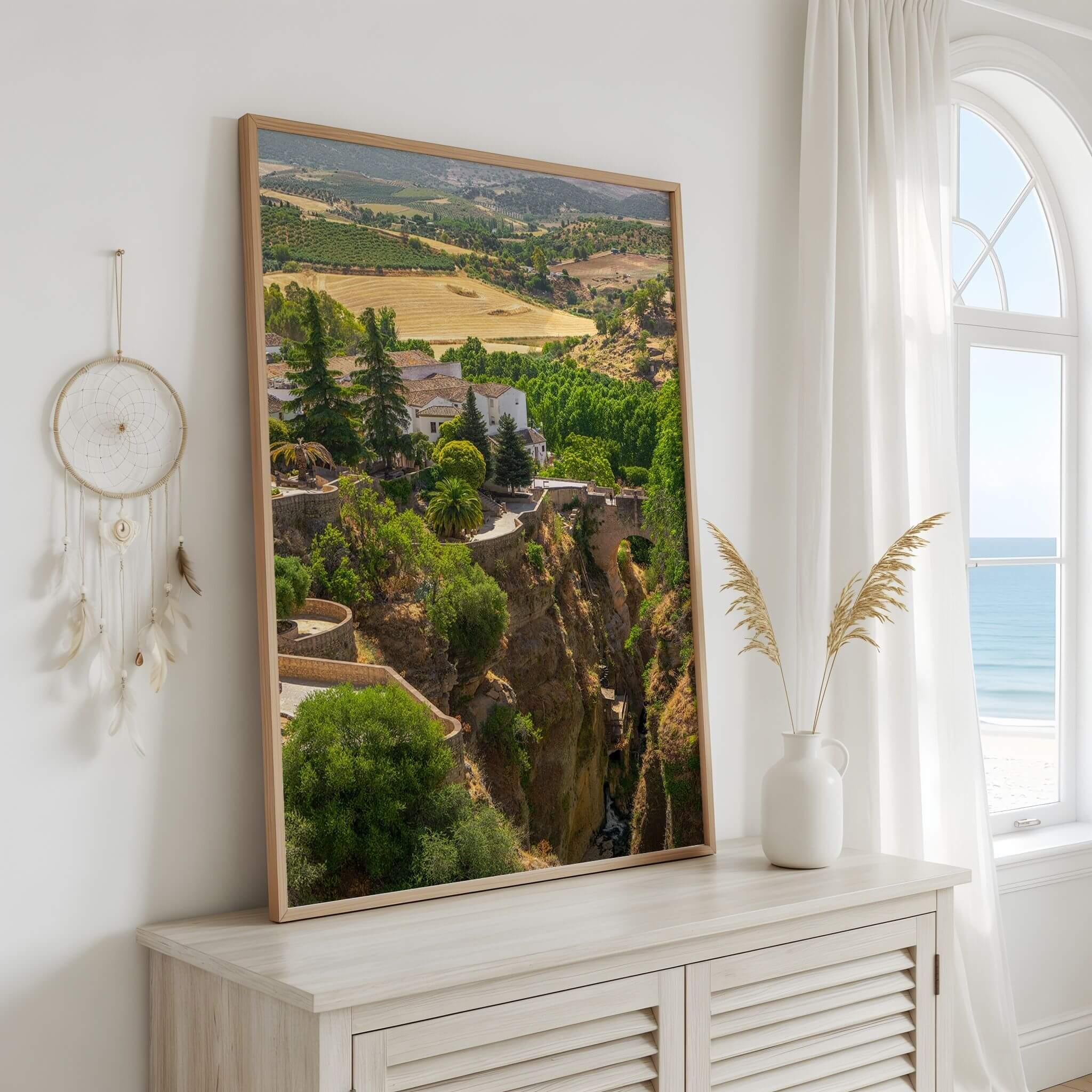 Ronda Above the Gorge framed fine art print displayed in a bright coastal interior, featuring the dramatic El Tajo Gorge and Andalusian landscape of Ronda, Spain – Abigail Diane Photography