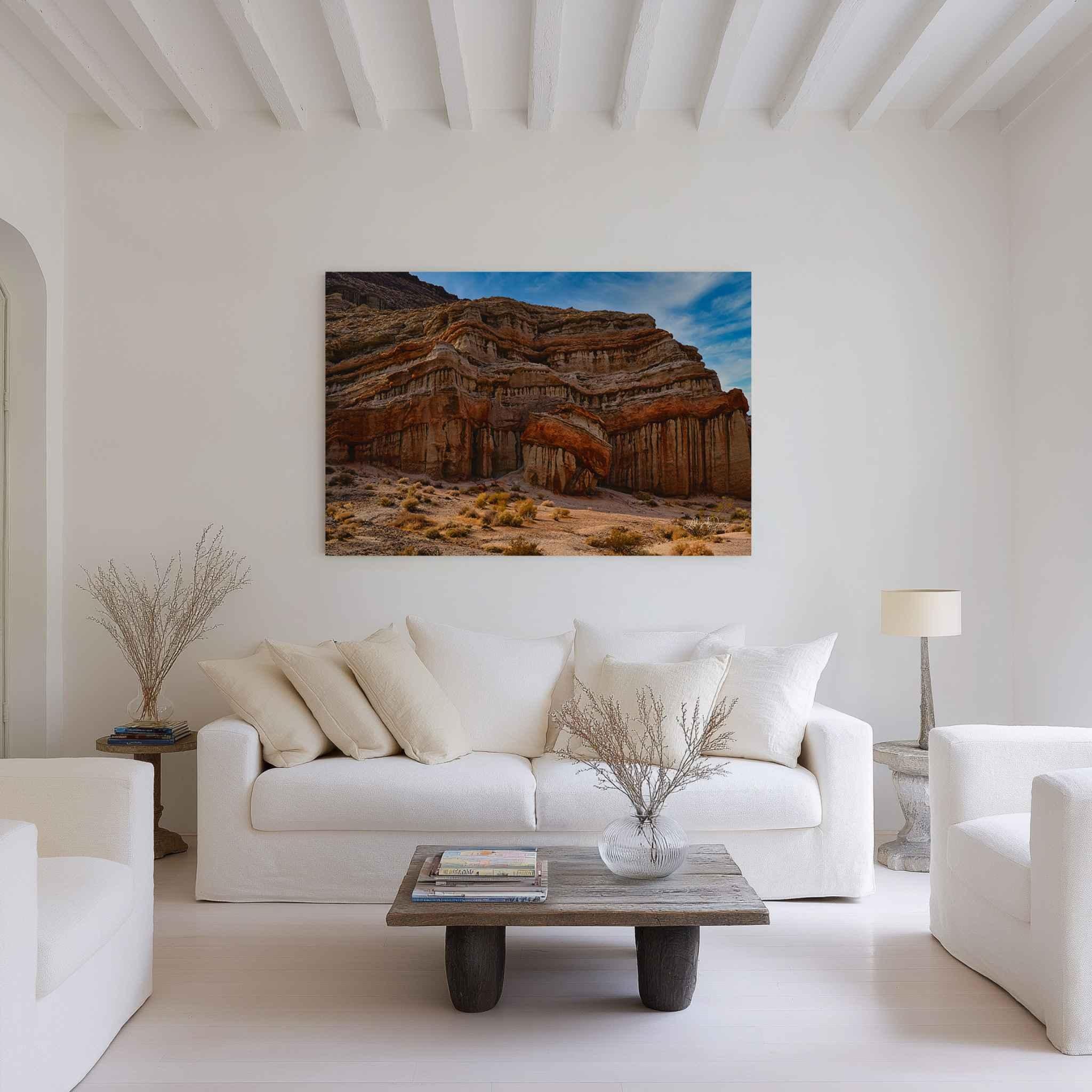 Sculpted by Time canvas print featuring California desert rock formations displayed above a white sofa in a neutral contemporary living room.