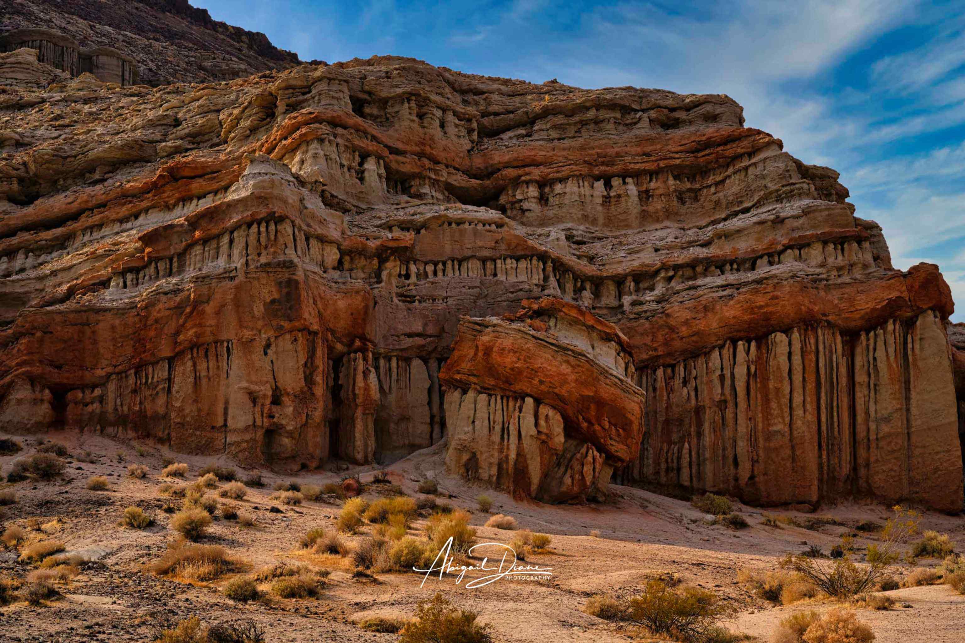 Sculpted by Time at Red Rock Canyon State Park, California, featuring dramatic layered red, rust and sandstone rock formations photographed by Abigail Diane Photography.