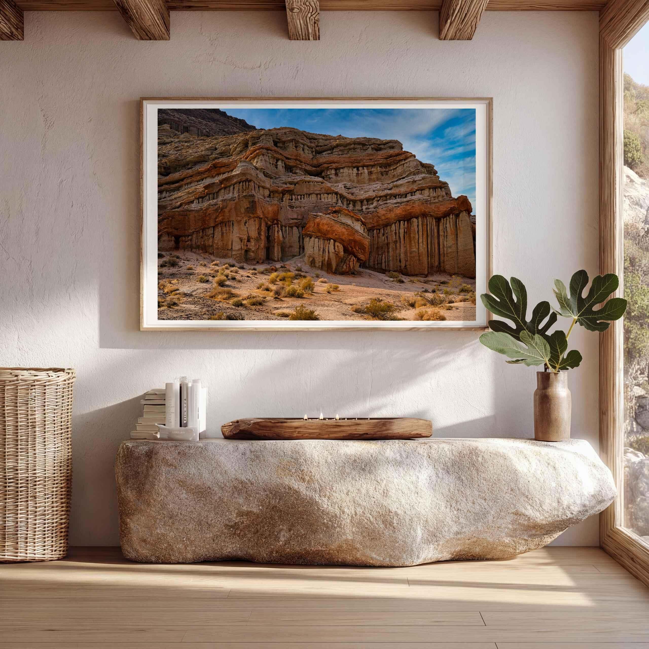 Sculpted in Time framed fine art print featuring California desert rock formations displayed above a stone console in a warm natural interior.