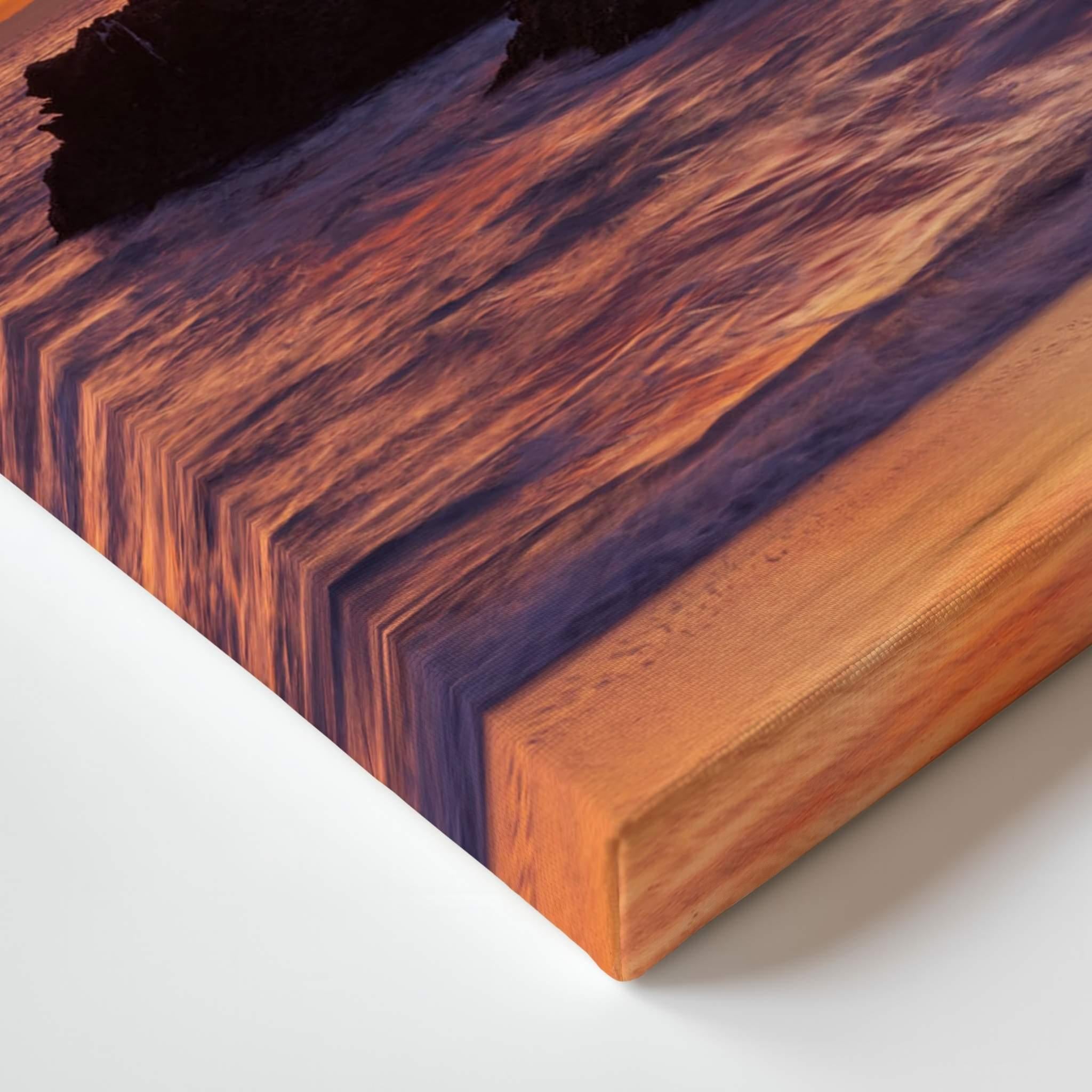A close-up of a rectangular wooden board or block with a rich woodgrain pattern, showing a dark purple-brown center and warm orange-brown edges, photographed on a white surface.