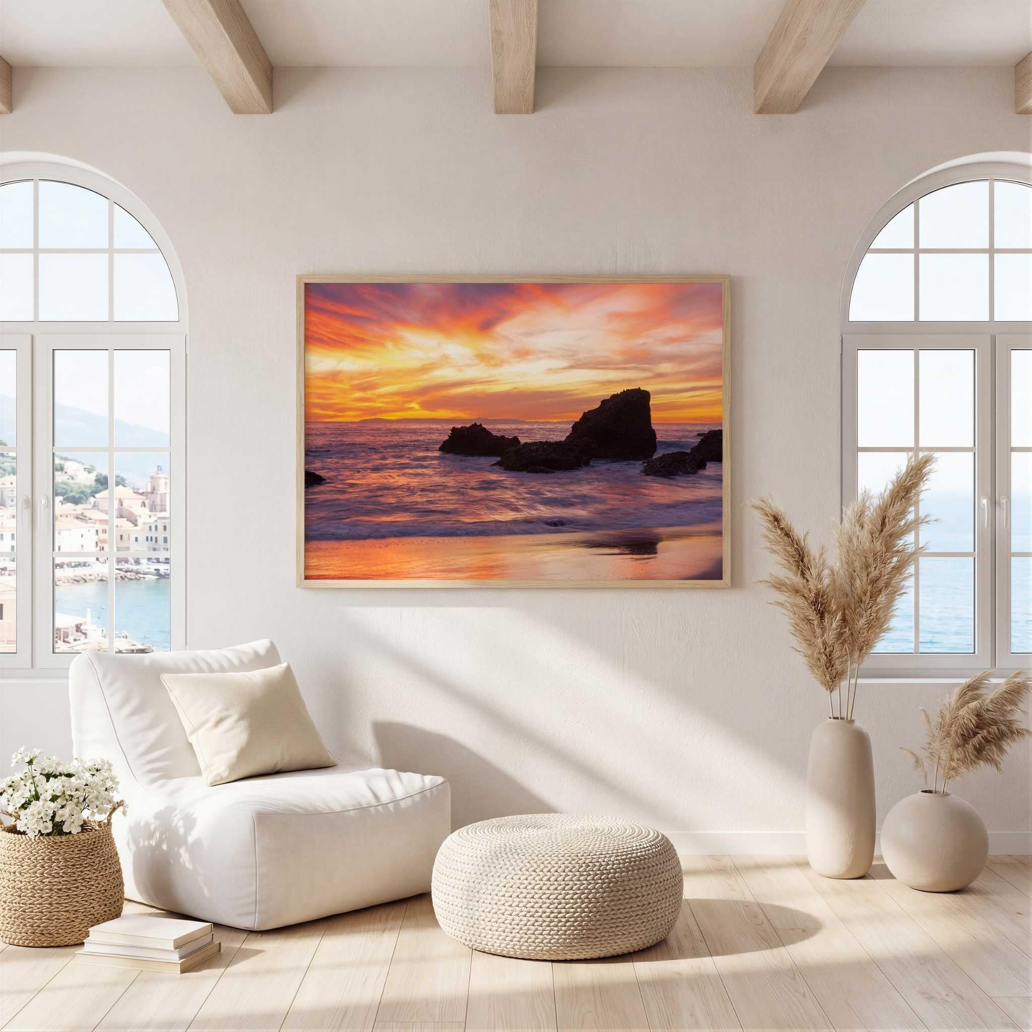 Sherbet Sunset fine art canvas print by Abigail Diane Photography displayed in a bright Mediterranean-inspired living room with arched windows, neutral décor, and natural oak frame, featuring a vibrant Laguna Beach, California sunset.