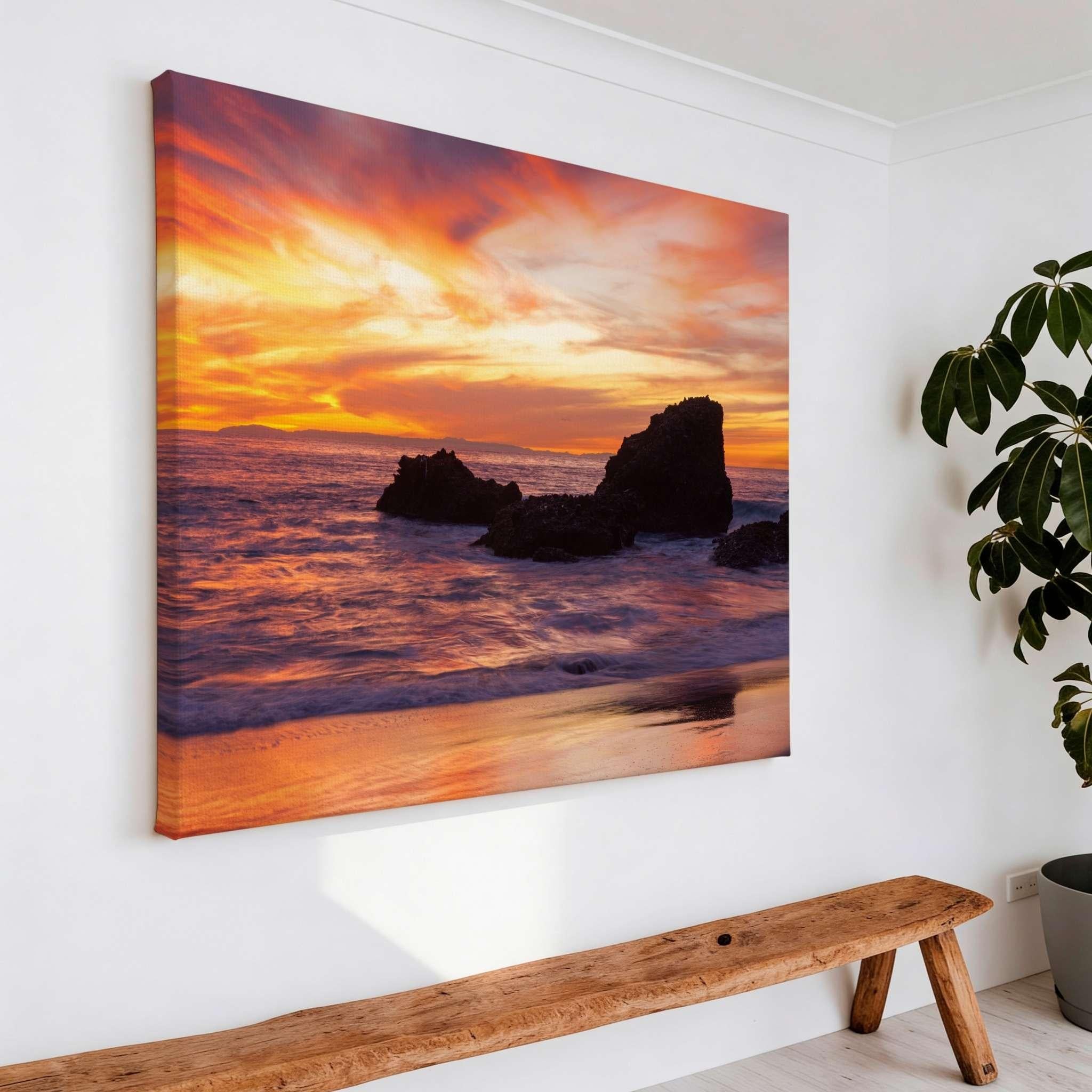 Sherbet Sunset gallery-wrapped canvas print displayed above a rustic wooden bench, featuring a vibrant Pacific Ocean sunset at Laguna Beach, California.