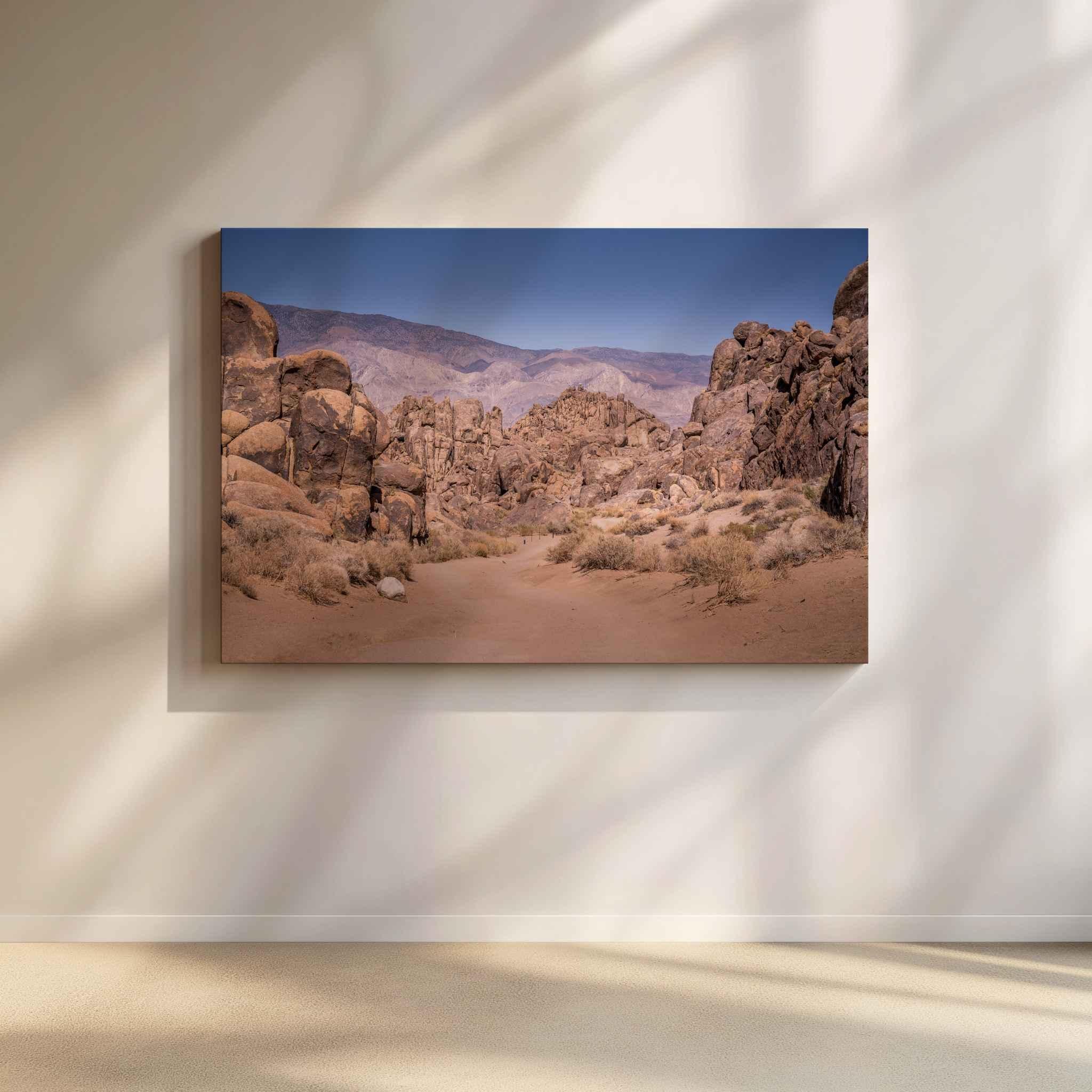 Sierra Desert Passage canvas wall art showing the rugged Alabama Hills and Eastern Sierra landscape near Lone Pine, California, on a softly lit neutral wall.