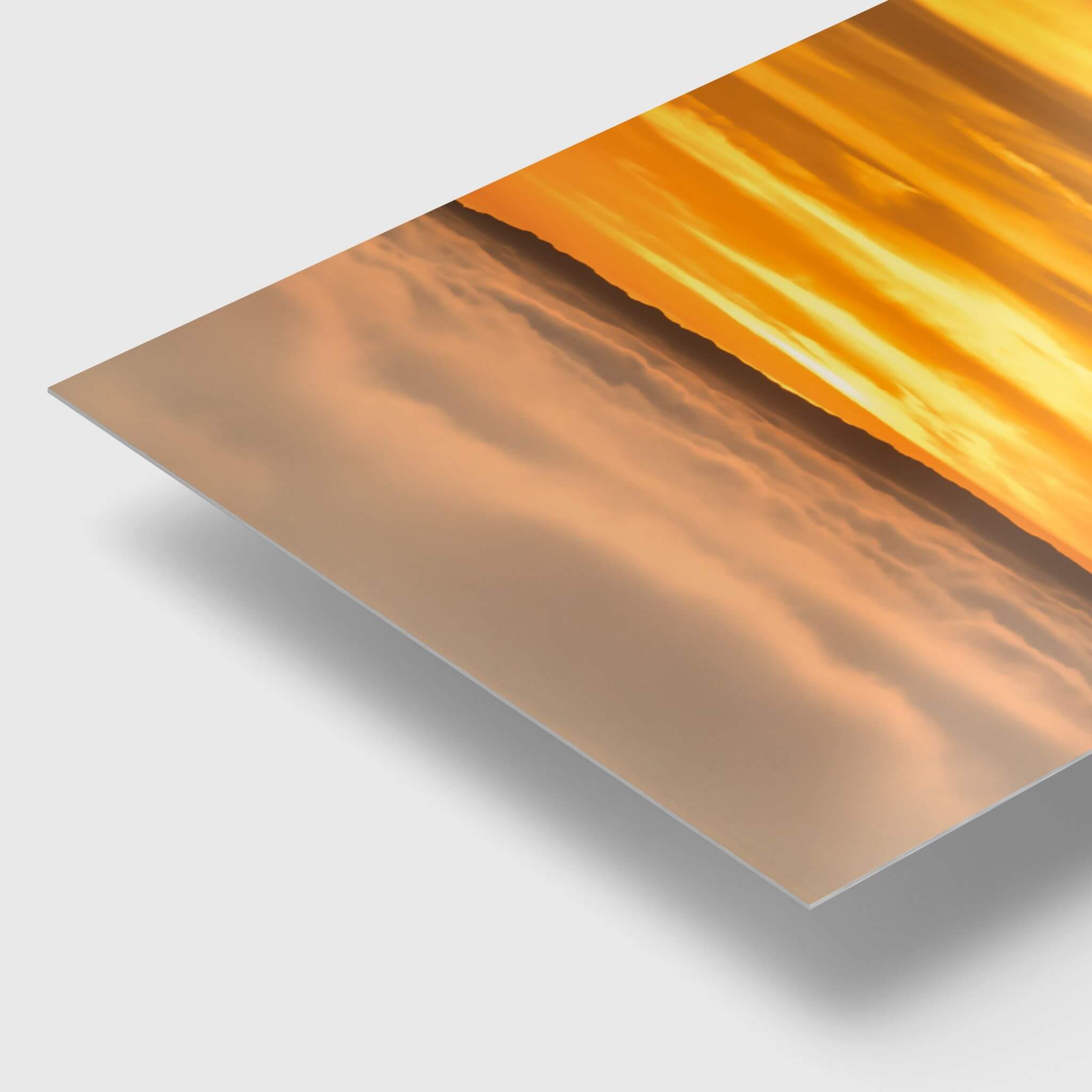 Close-up angled view of Soaring Above the Clouds HD metal print by Abigail Diane Photography, highlighting the sleek edge, glossy finish, and vibrant golden sunset colours above a sea of clouds.