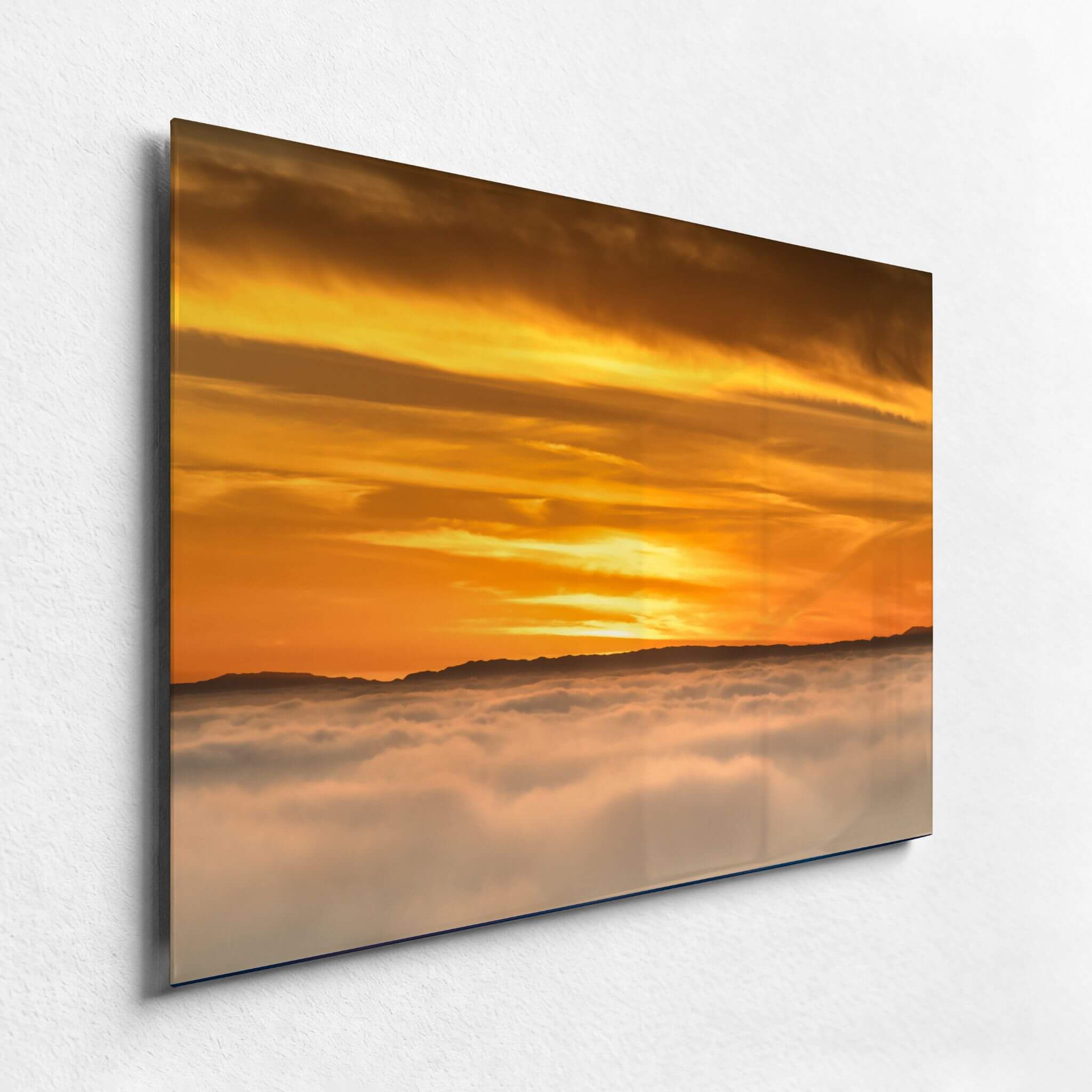 Premium HD metal print of Soaring Above the Clouds by Abigail Diane Photography displayed on a white wall, showcasing a dramatic golden sunset above a blanket of clouds with brilliant color and high-definition clarity.