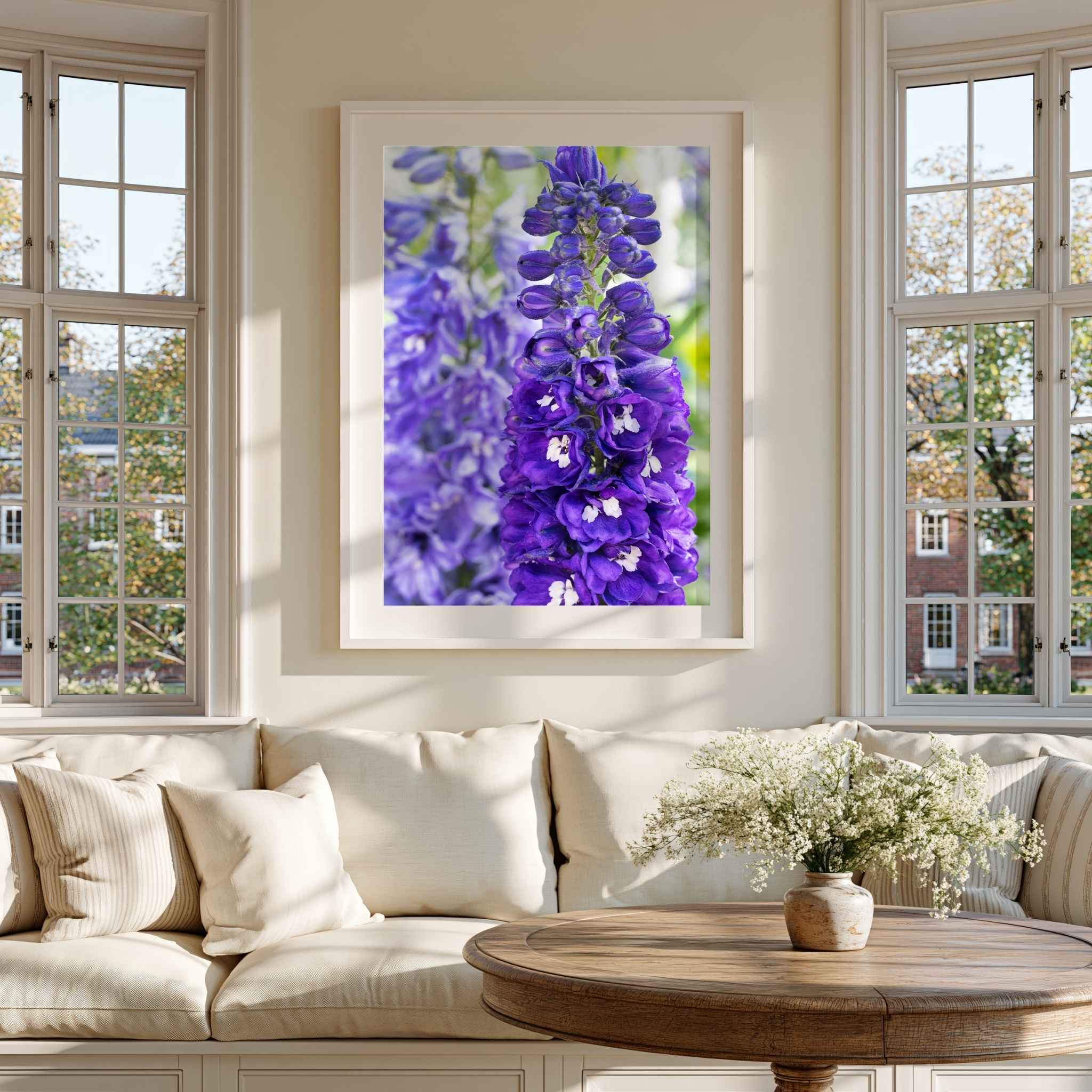 Violet Harmony purple larkspur fine art print framed in white and displayed in a bright neutral living room by Abigail Diane Photography.