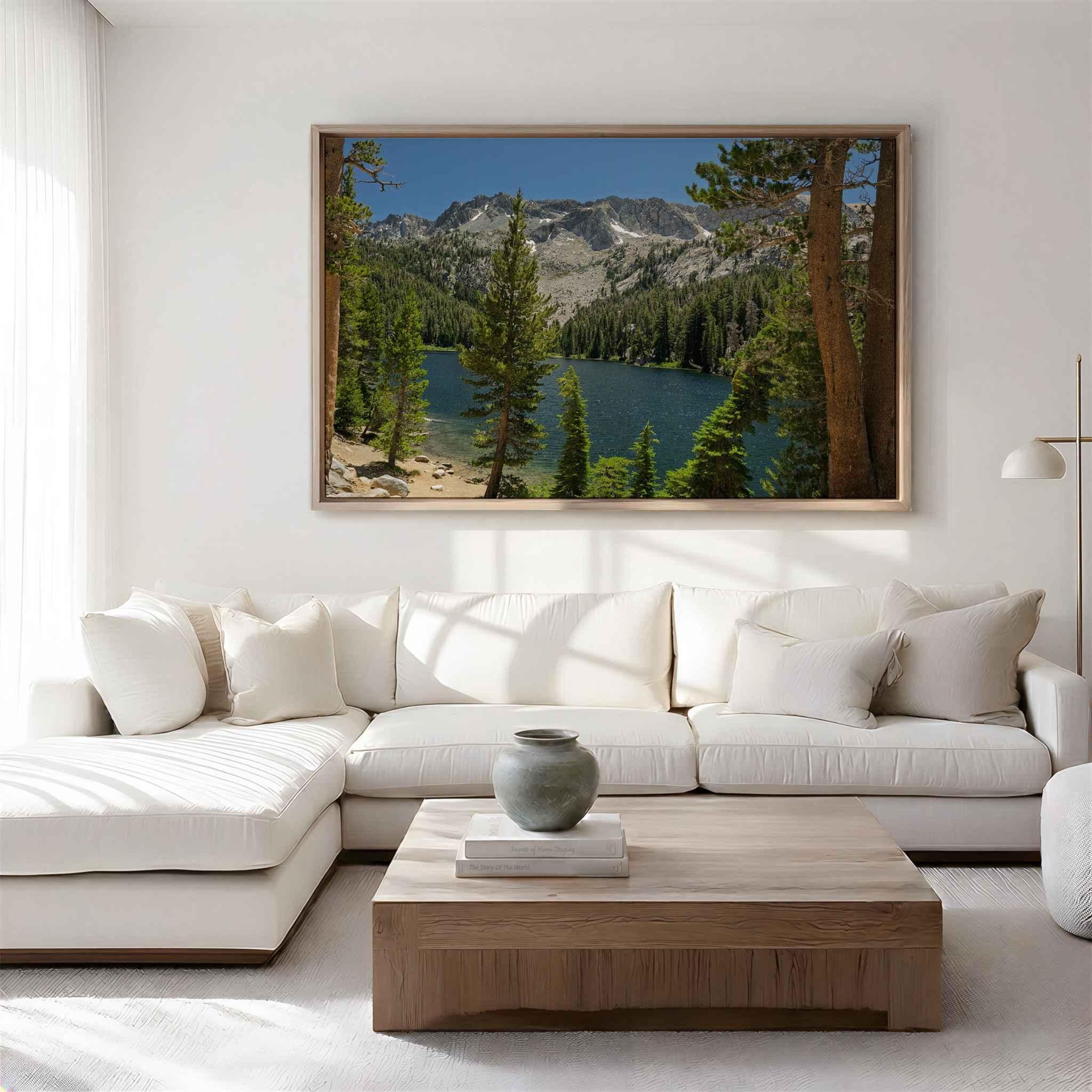Where the Trail Gives Way to Still Waters metal print displayed above a white sectional, featuring an alpine lake and Sierra Nevada mountains near Mammoth Lakes, California.