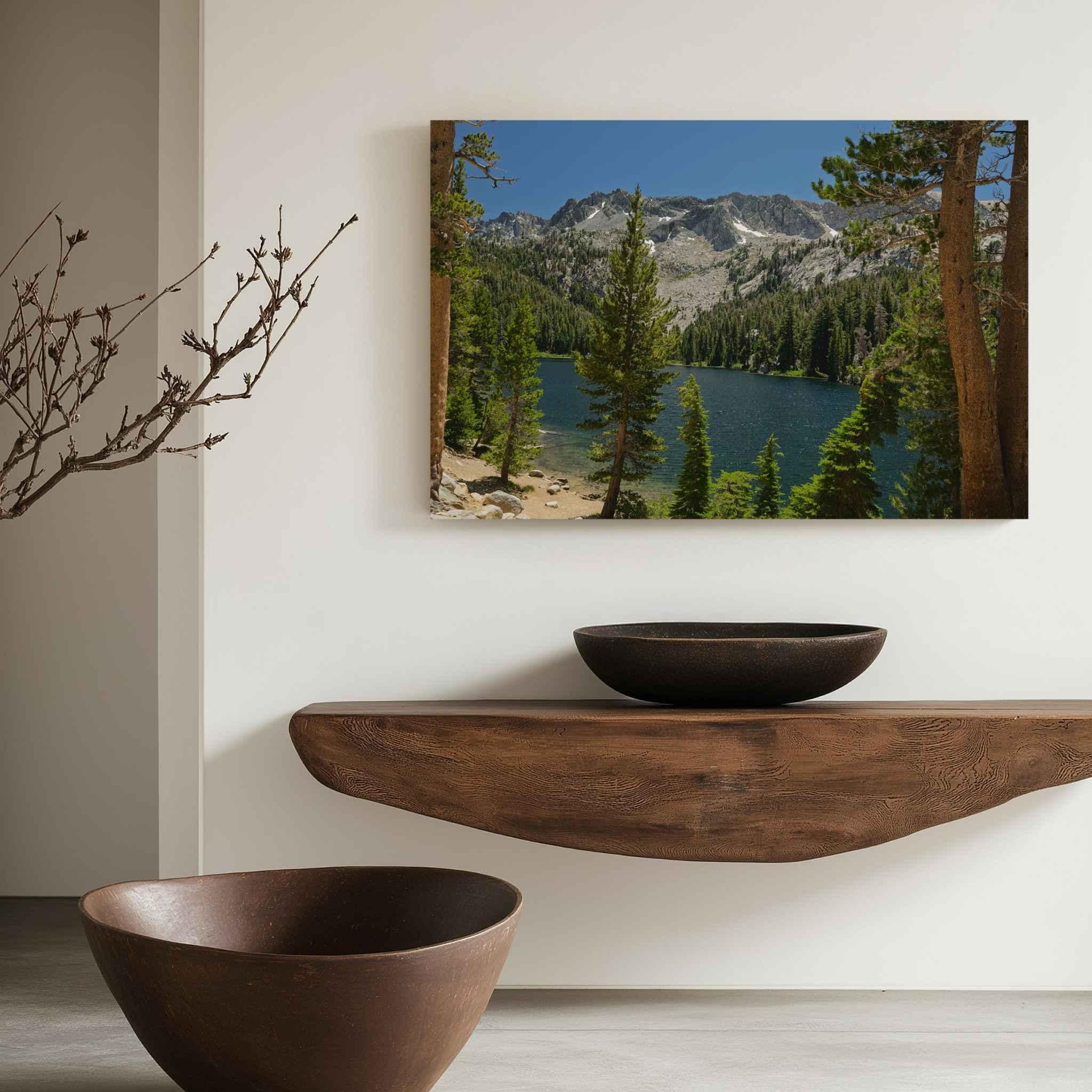 Where the Trail Gives Way to Still Waters metal print displayed above a sculptural wood console, featuring an Eastern Sierra alpine lake near Mammoth Lakes, California.
