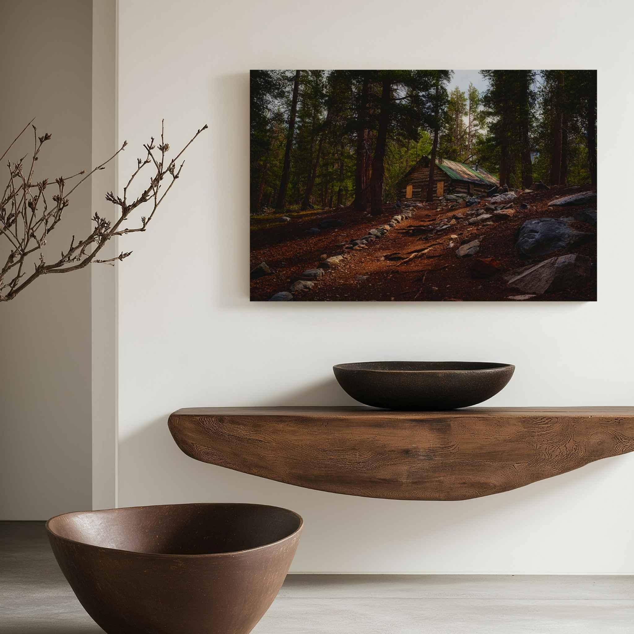 Where the Trail Meets the Past canvas print featuring historic Mahan Cabin near Mammoth Lakes, California, displayed above a wood console in a neutral interior.