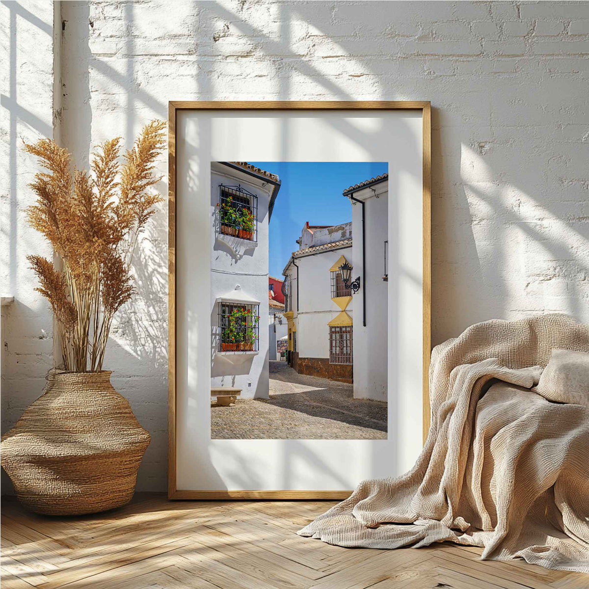 Whitewashed Streets of Setenil framed fine art print displayed in a warm neutral interior – Abigail Diane Photography