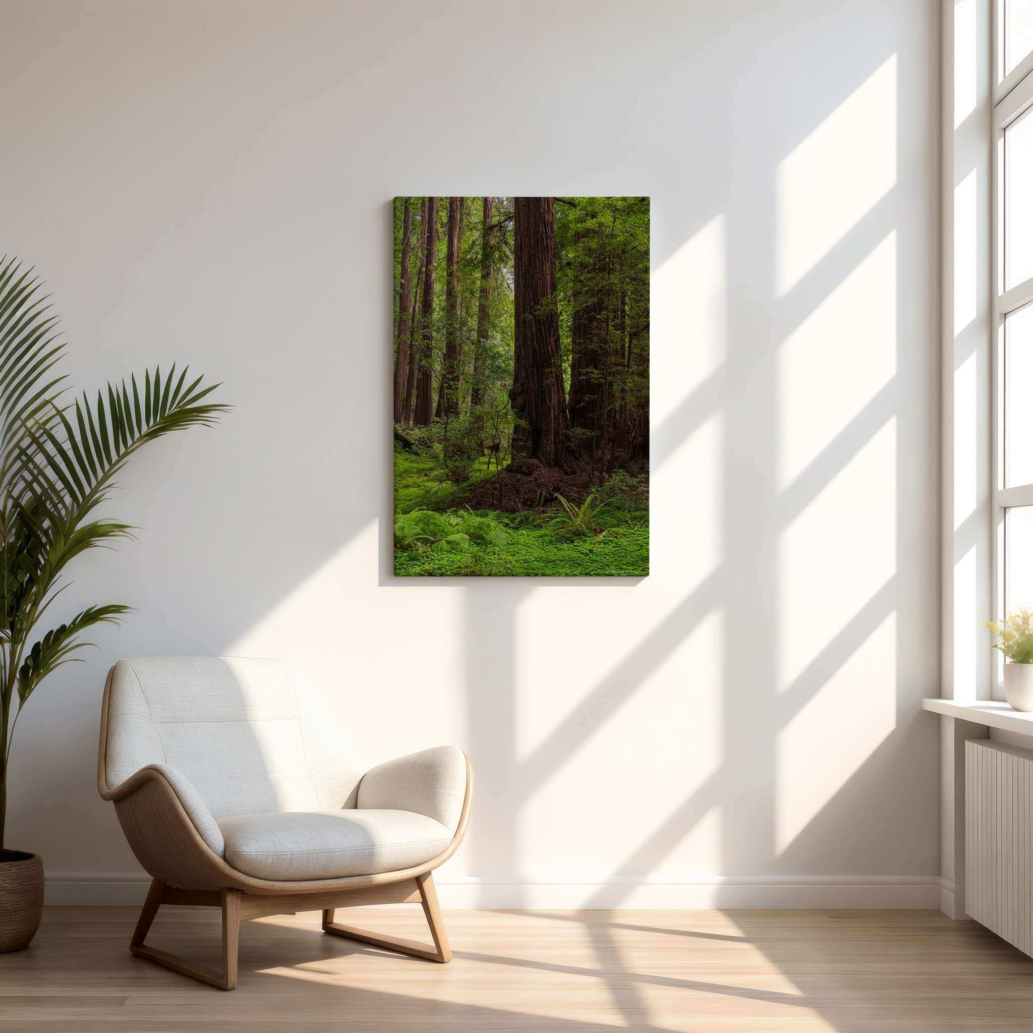 Ancient Stillness Among the Redwoods canvas wall art by Abigail Diane Photography displayed in a bright Scandinavian-inspired living room with a cream lounge chair, pale oak floors, indoor palm, and large sunlit windows, creating a peaceful nature-inspired interior featuring California redwood forest photography.