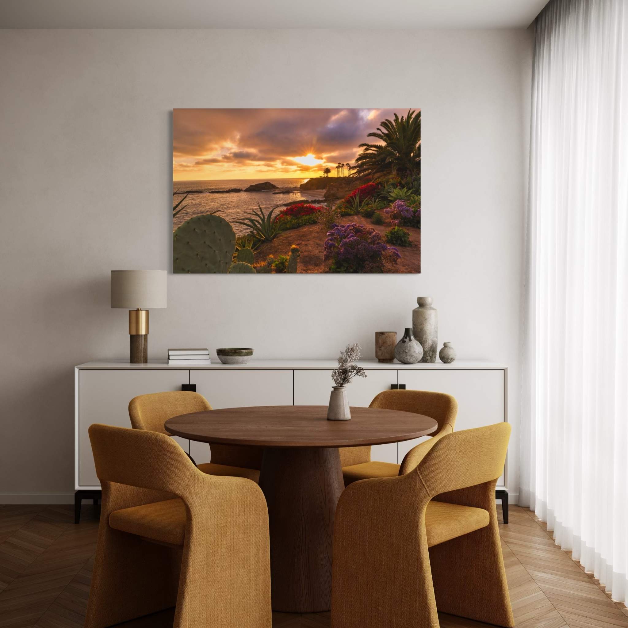 Basking in the Golden Sunset dye-sublimation metal print by Abigail Diane Photography displayed in a contemporary dining room, showcasing a warm Laguna Beach California sunset with coastal flowers, palm trees, and the Pacific Ocean.