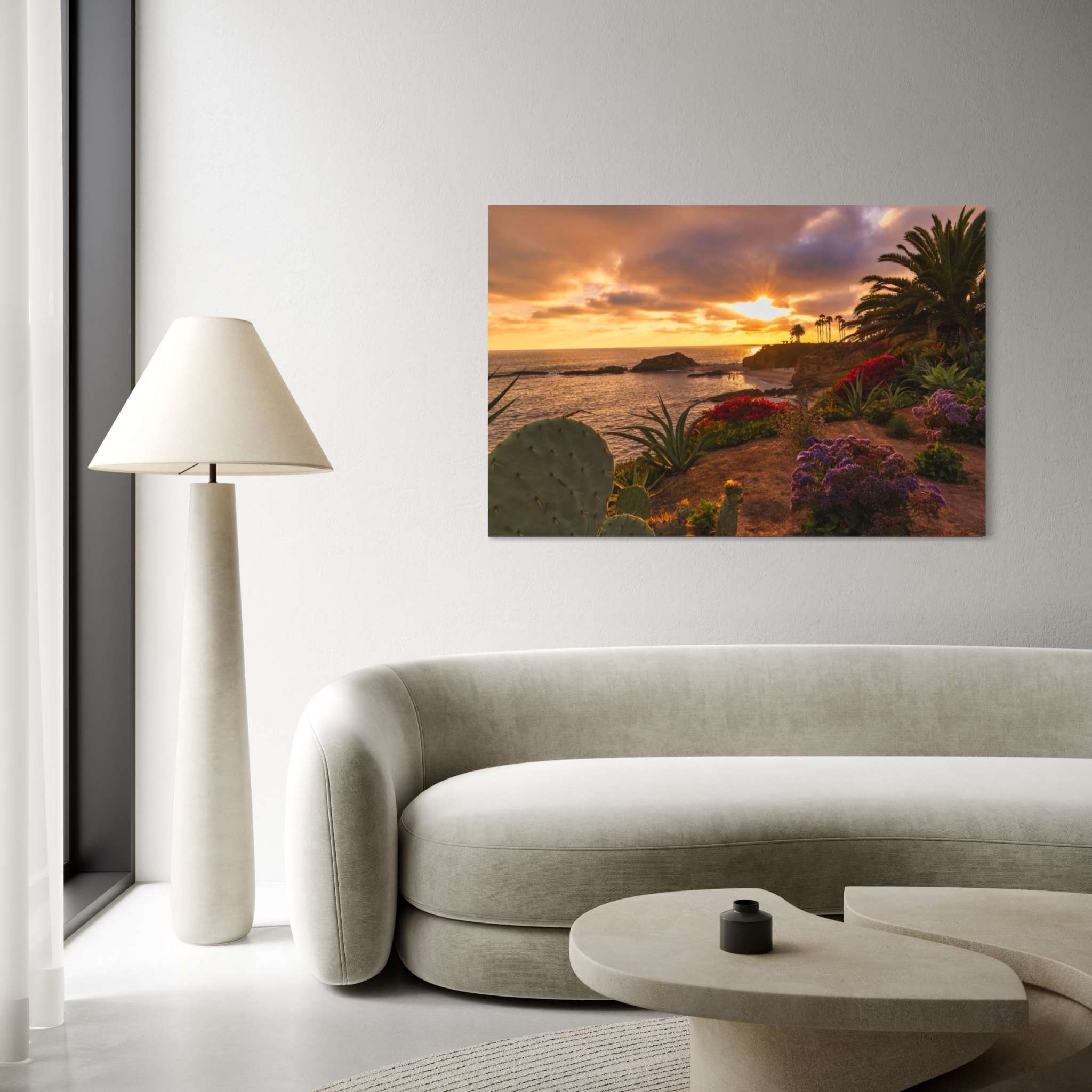 Basking in the Golden Sunset dye-sublimation metal print by Abigail Diane Photography displayed above a contemporary curved sofa, featuring a colorful Laguna Beach California sunset overlooking the Pacific Ocean.