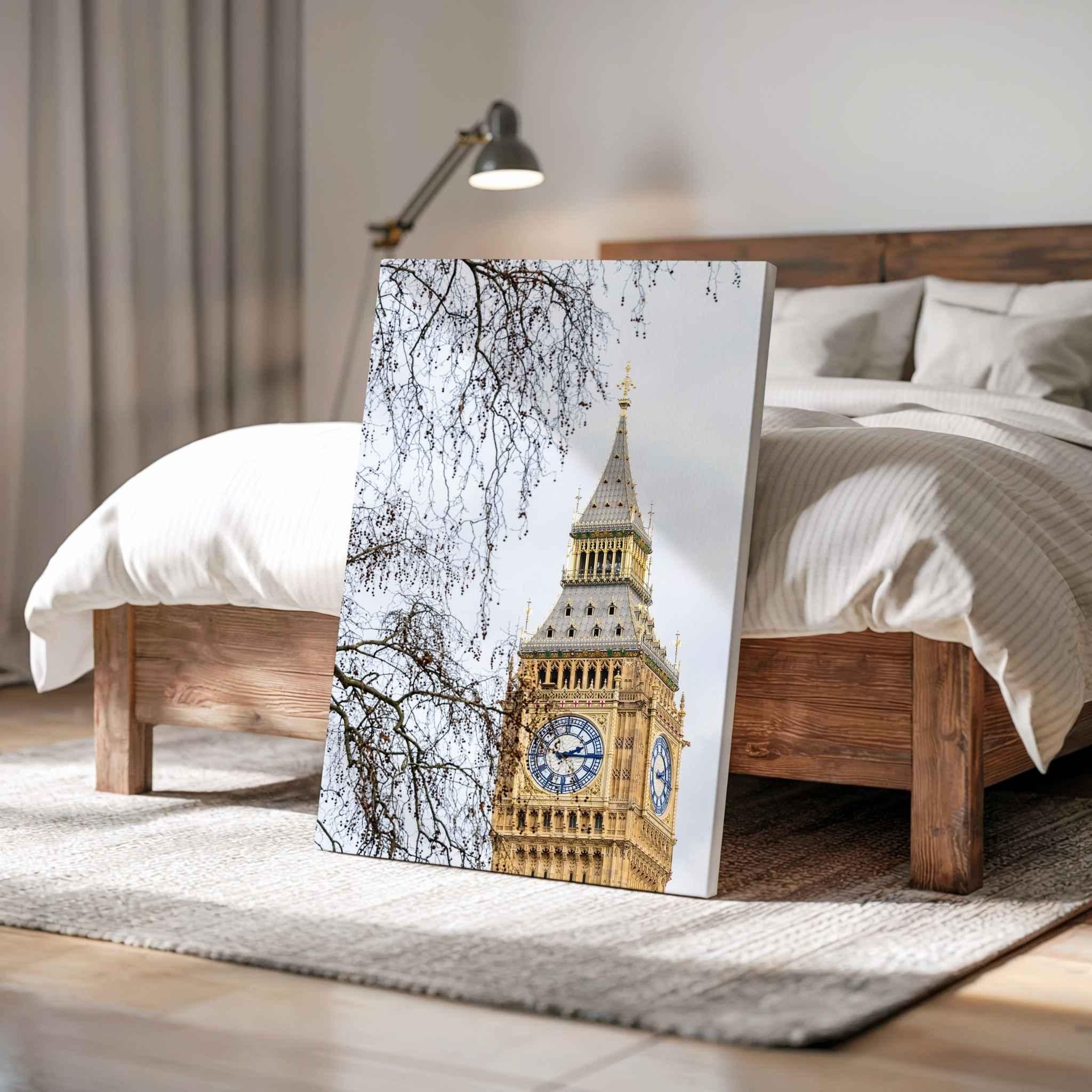 Gallery wrapped canvas print of the restored Big Ben clock tower in London displayed leaning against a wooden bed in a warm contemporary bedroom, showcasing the white canvas edge and premium gallery wrap by Abigail Diane Photography.