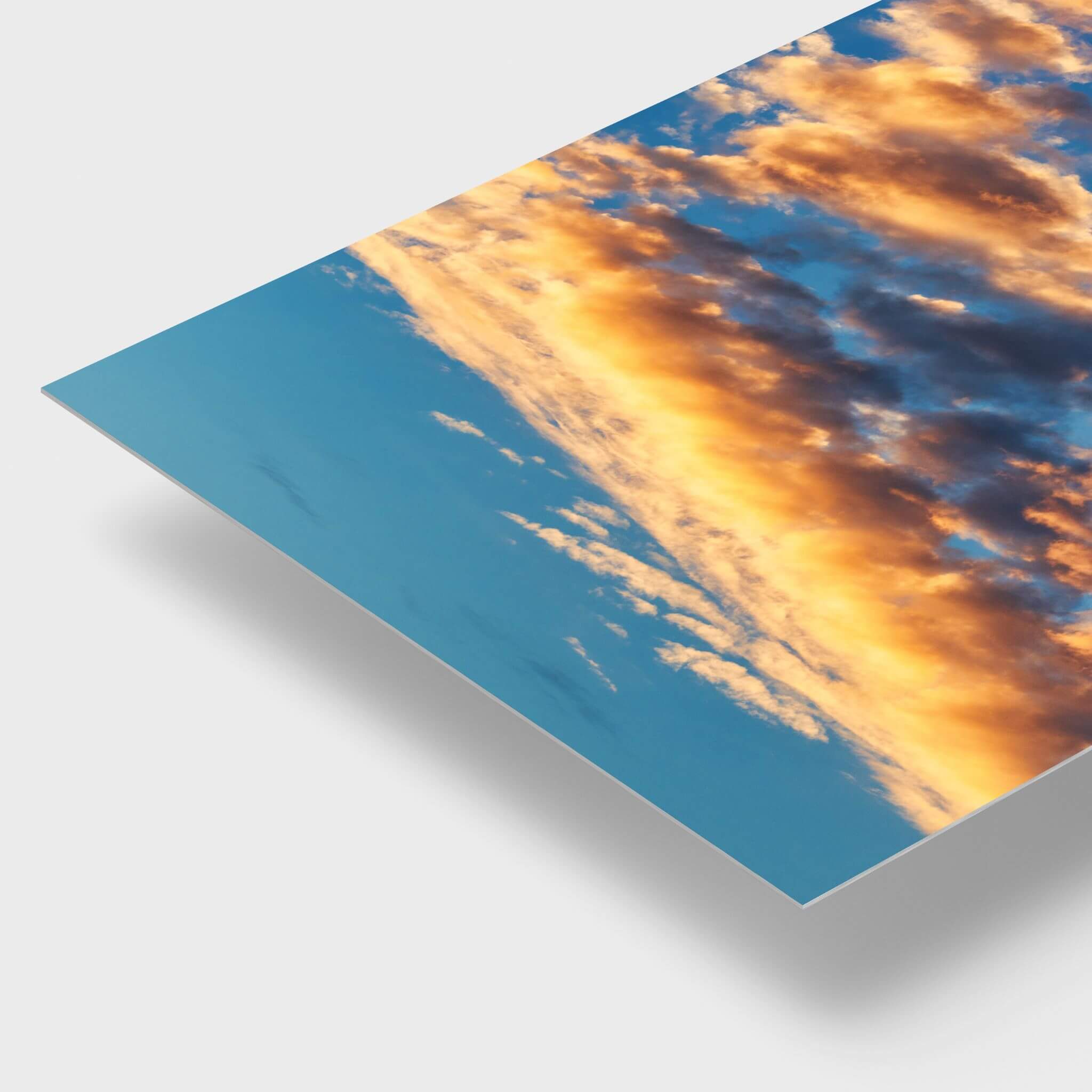 Blue and Gold Symphony dye-sublimation metal print detail showing vibrant golden clouds against a rich blue sky and the sleek edge of the metal panel.