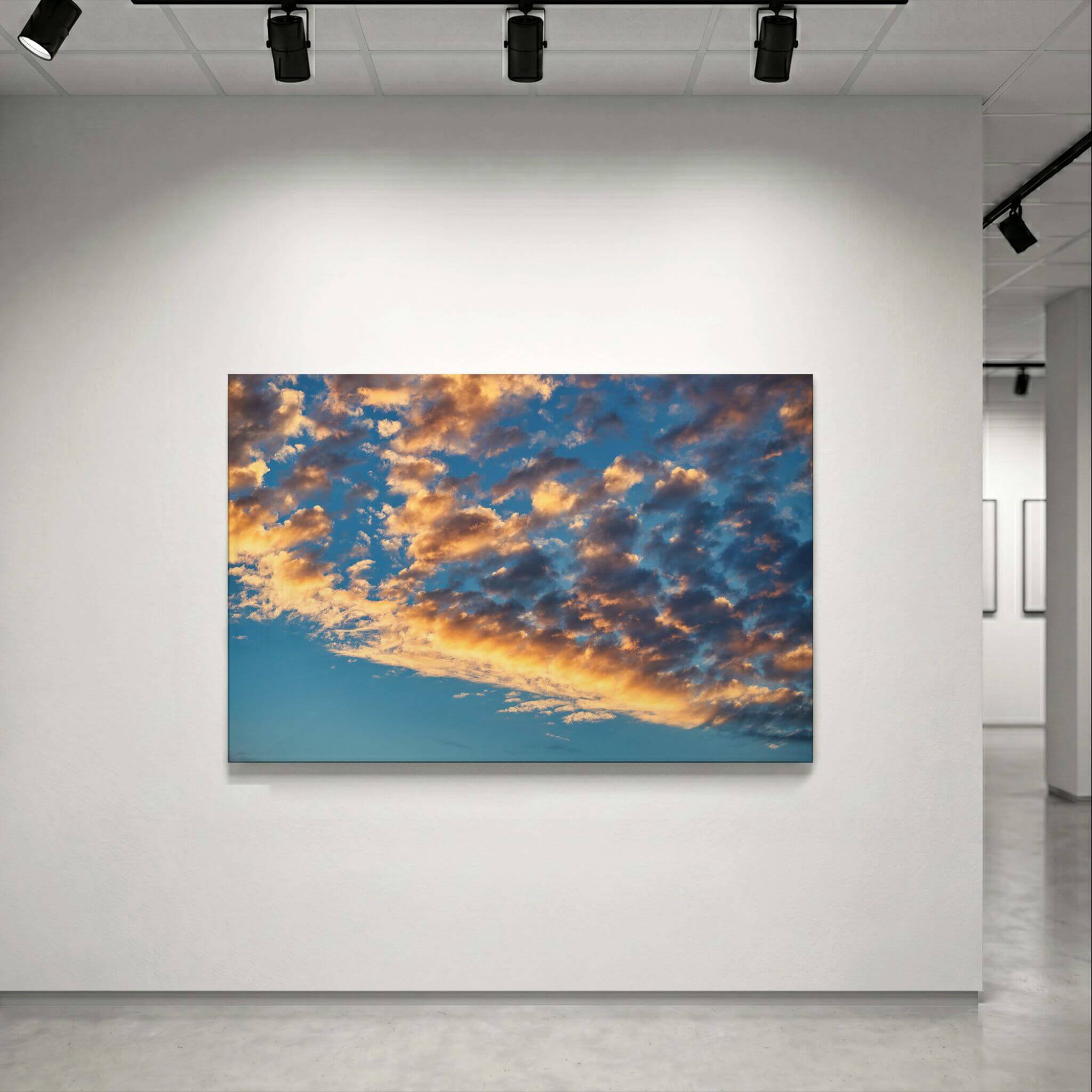 Blue and Gold Symphony metal print displayed on a clean gallery wall, highlighting the dramatic blue sky and glowing golden cloudscape. Photography by Abigail Diane Photography.