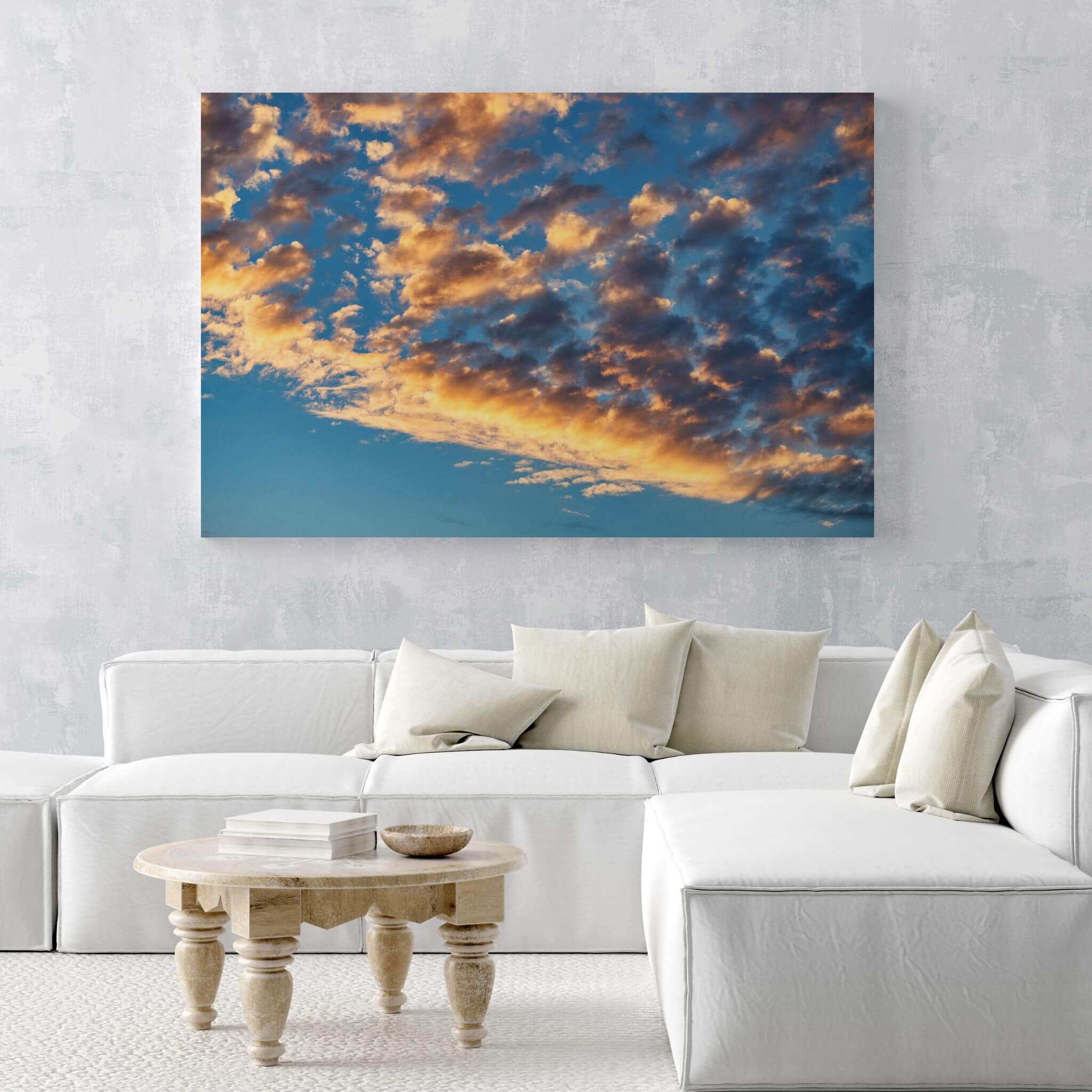 Large Blue and Gold Symphony of the sky metal wall art displayed above a white sectional sofa in a light neutral contemporary living room. Photography by Abigail Diane Photography.